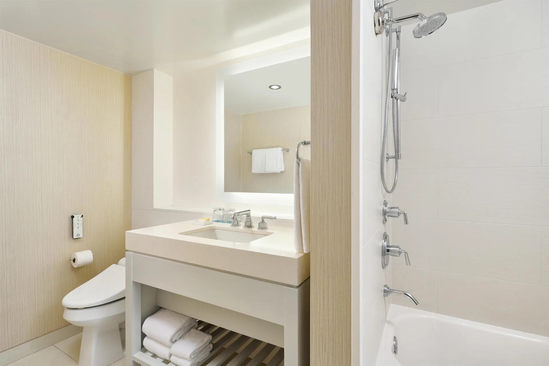 Bathroom vanity, toilet and shower-tub in a One Bedroom Ocean Front Suite at Hyatt Regency Waikiki Beach Resort & Spa.