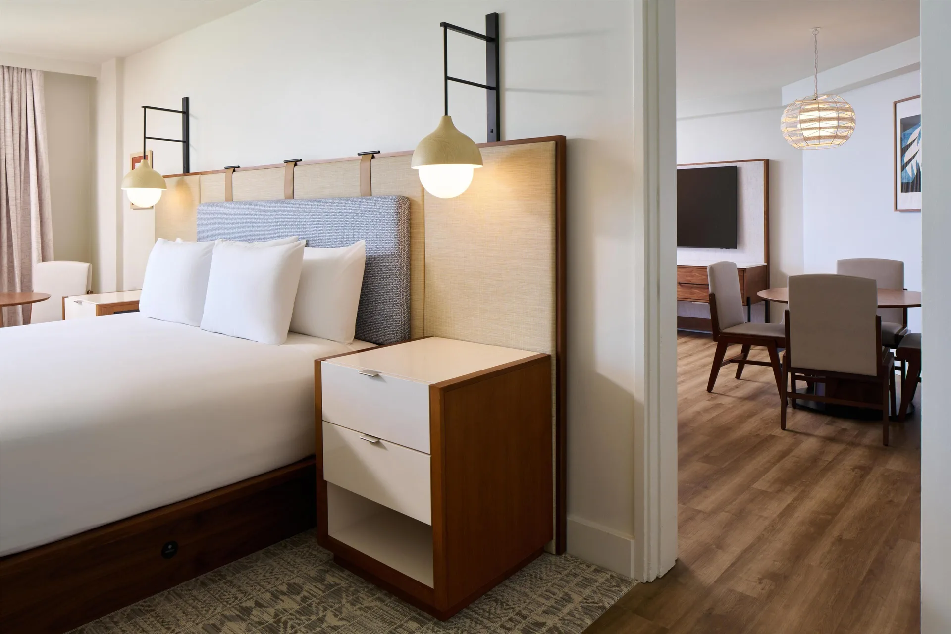 King bed and adjoining dining area in an ocean front suite at Hyatt Regency Waikiki Beach Resort & Spa.