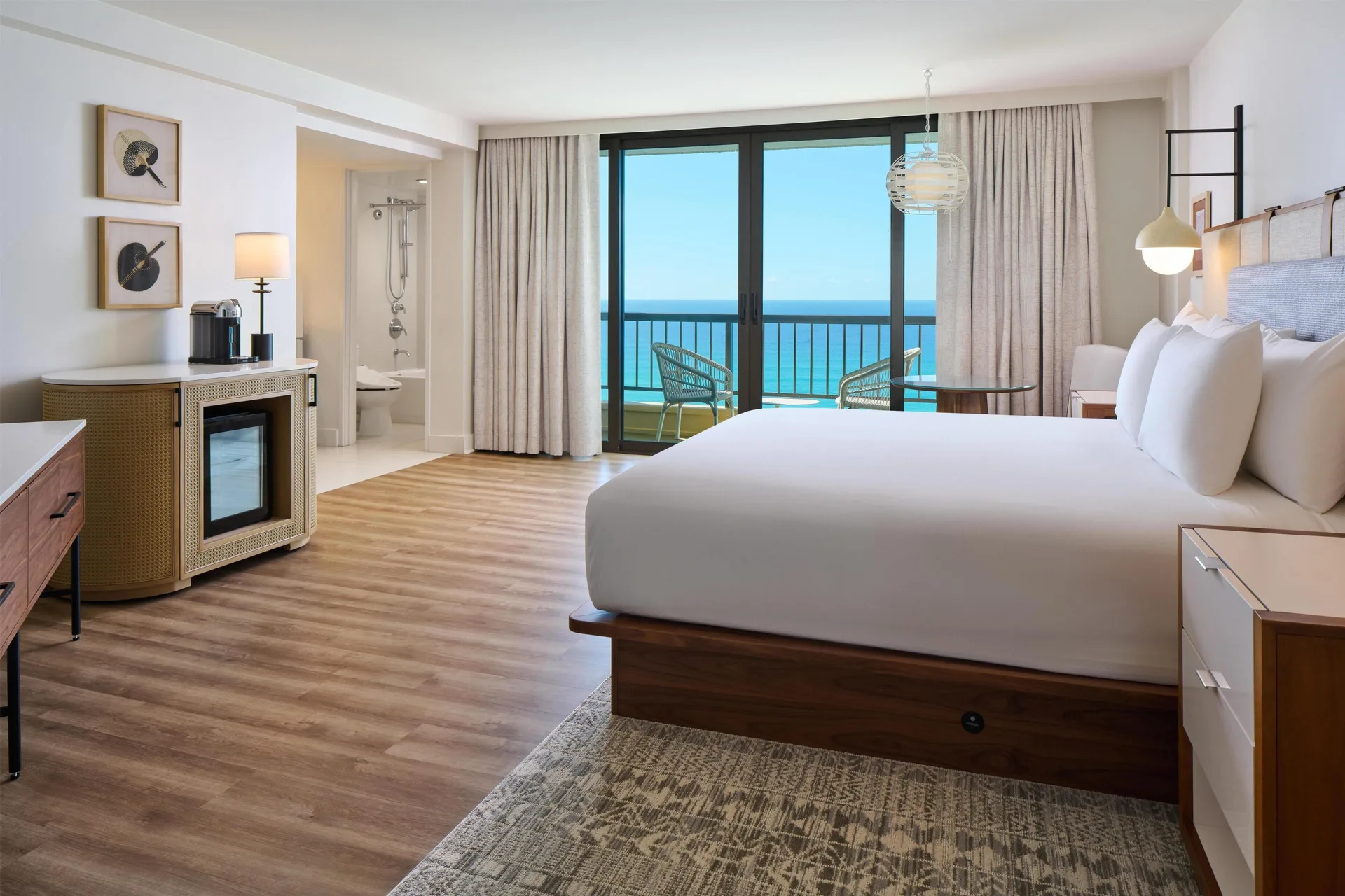 Ocean front suite bedroom with king bed and balcony view at Hyatt Regency Waikiki Beach Resort & Spa.