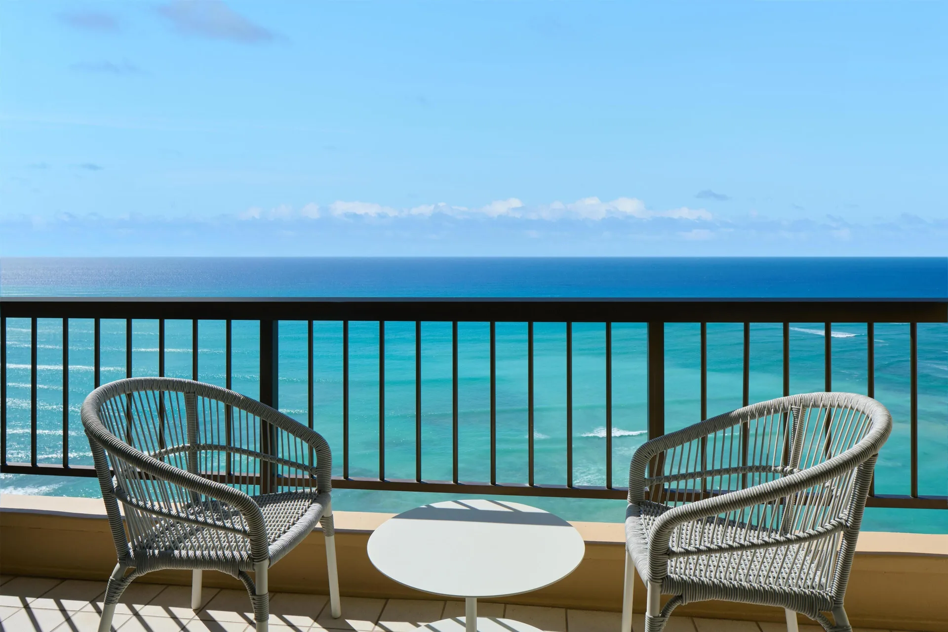 Balcony chairs and ocean view from an ocean front suite at Hyatt Regency Waikiki Beach Resort & Spa.