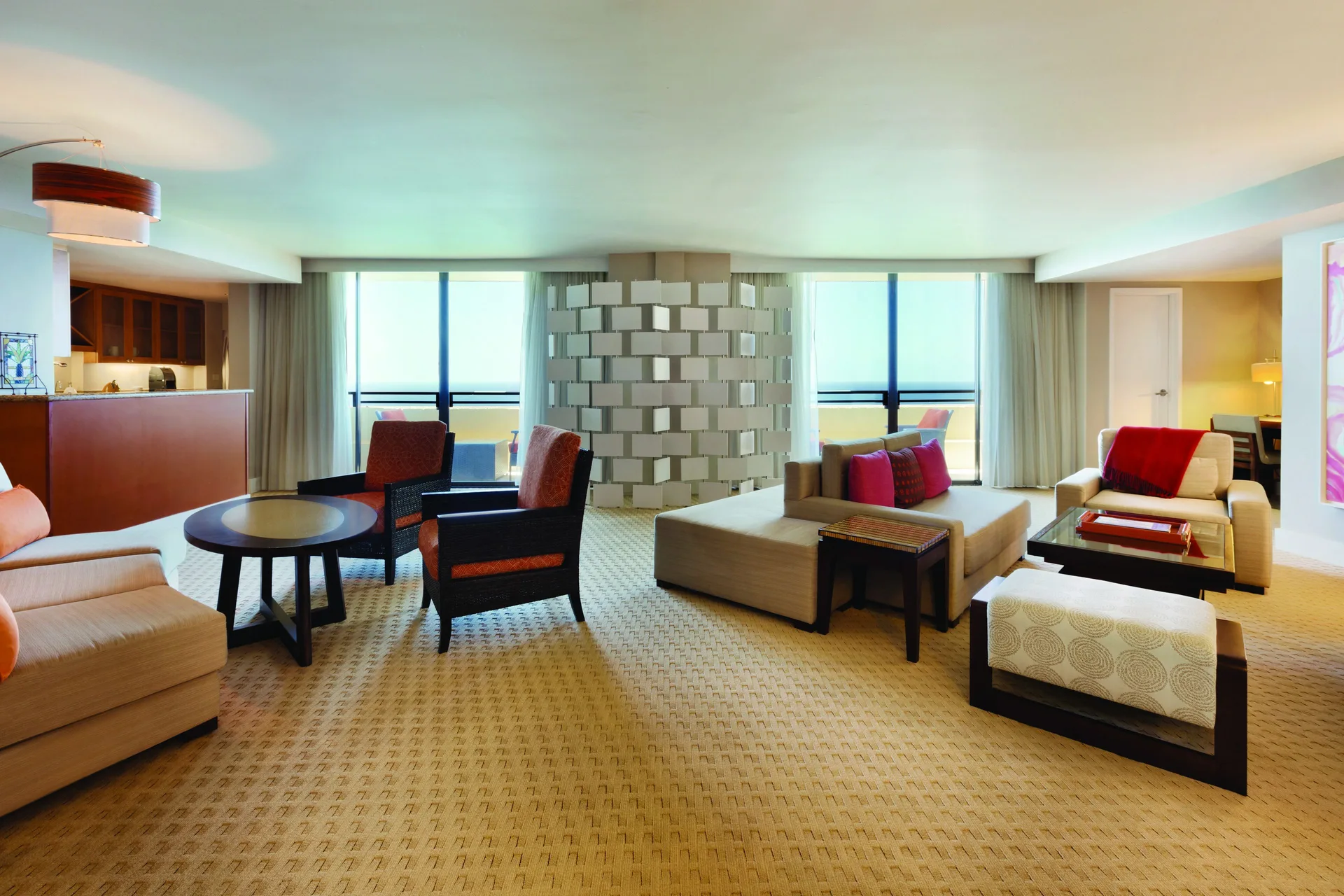 Penthouse suite living room with kitchenette and ocean-facing windows at Hyatt Regency Waikiki Beach Resort & Spa.