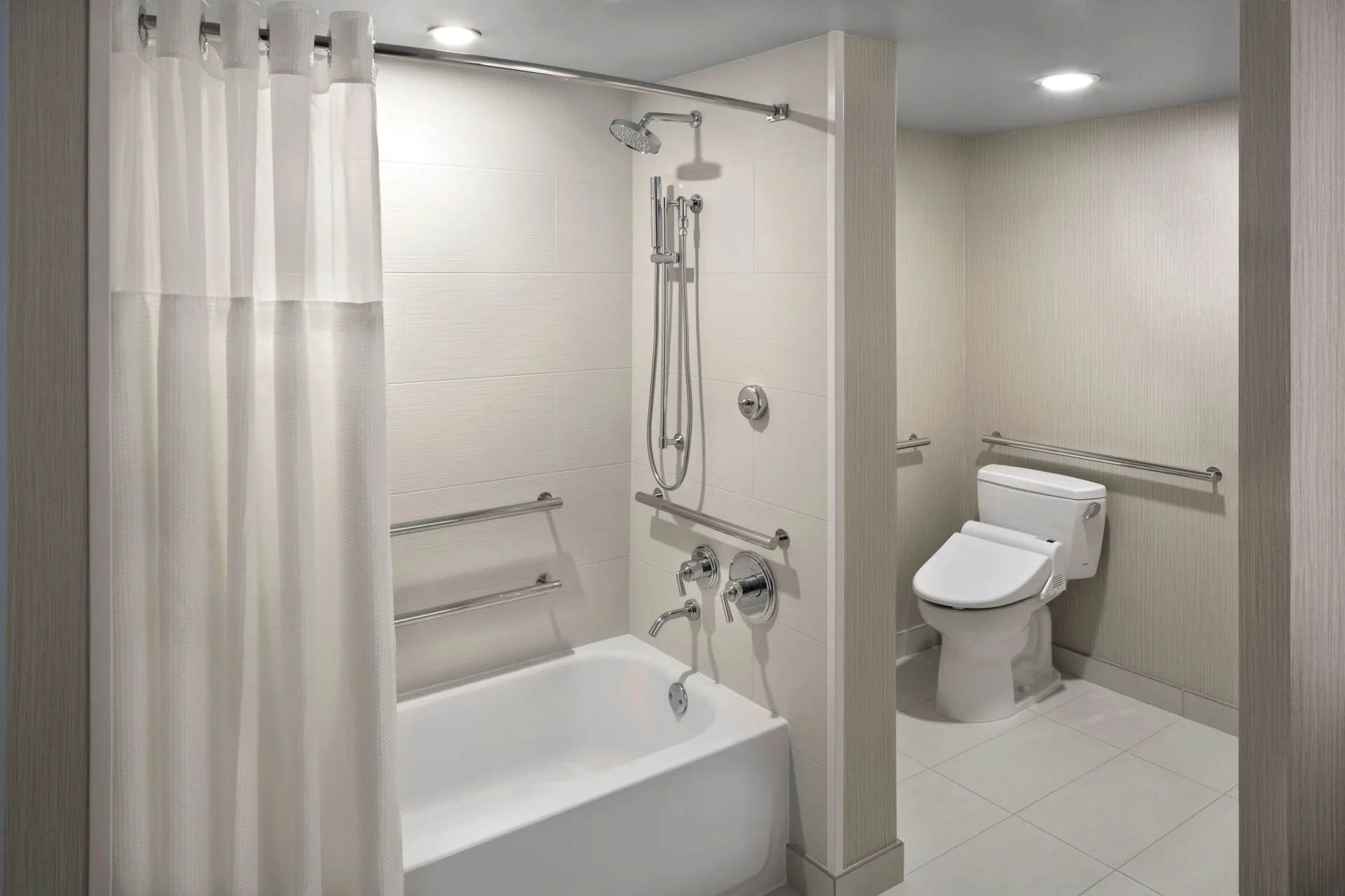 Accessible bathroom with bathtub and grab bars at Hyatt Regency Waikiki Beach Resort & Spa.