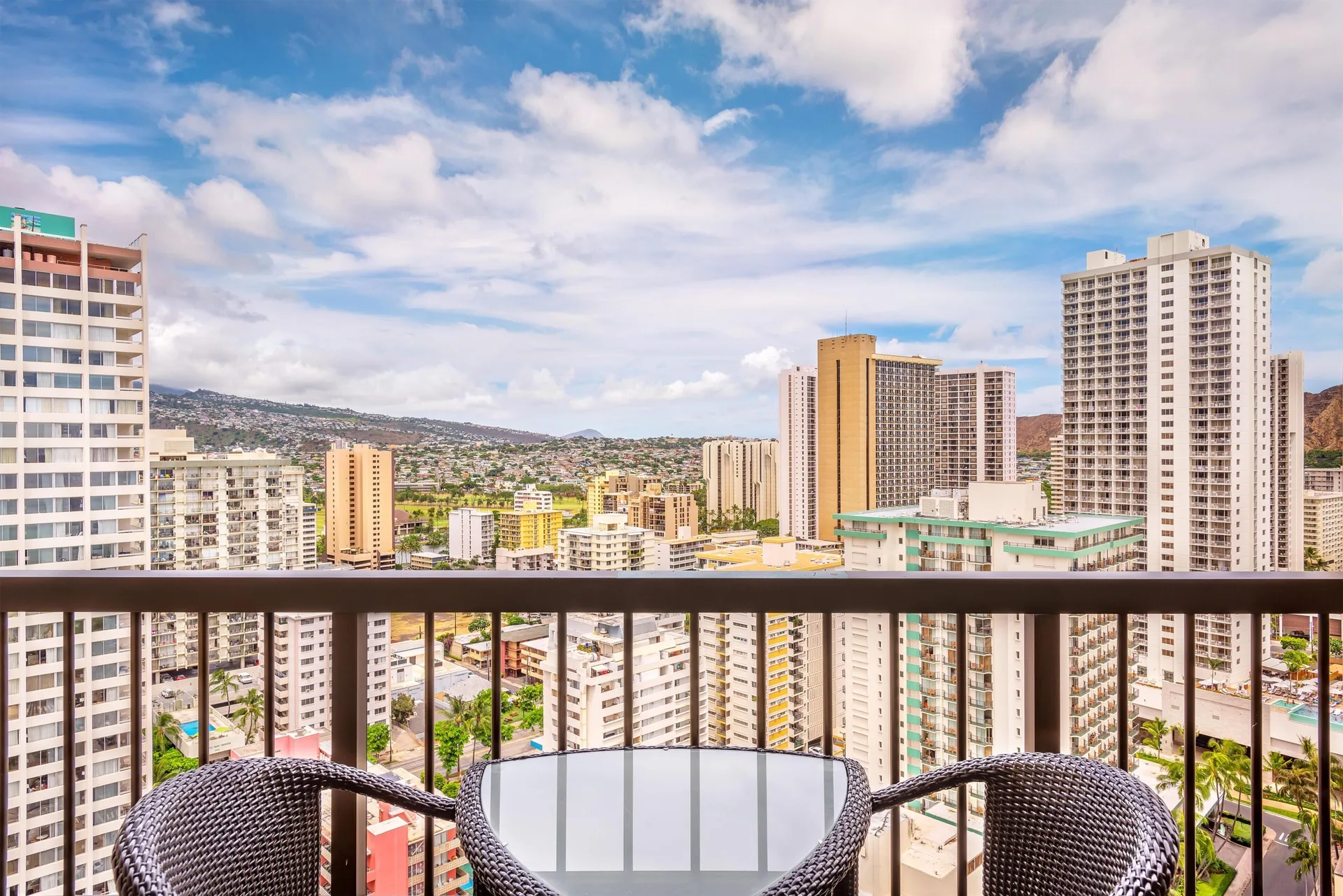 Balcony seating with Waikiki city and mountain views at Hyatt Regency Waikiki Beach Resort & Spa.