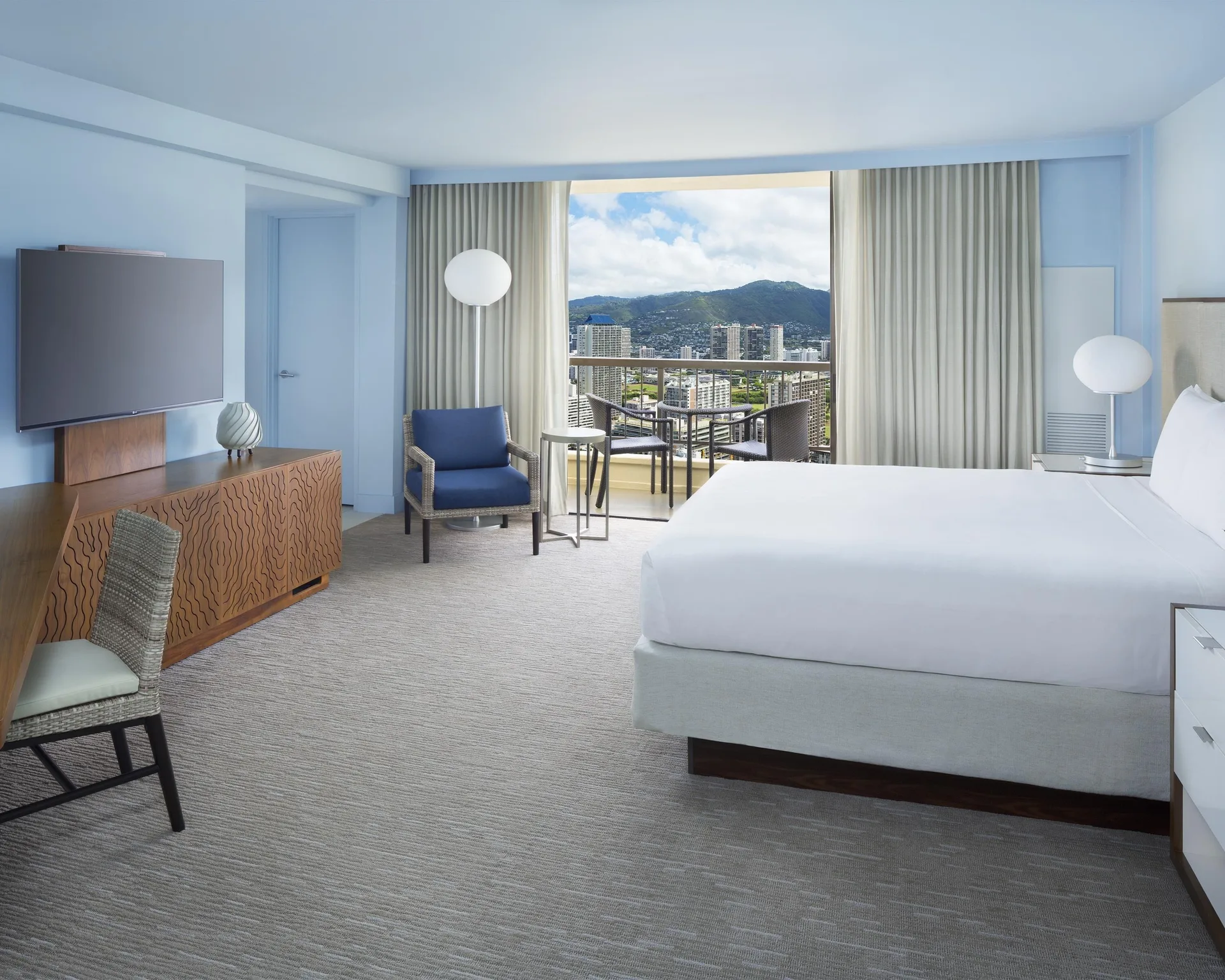 King bed guest room with city view balcony at Hyatt Regency Waikiki Beach Resort & Spa.