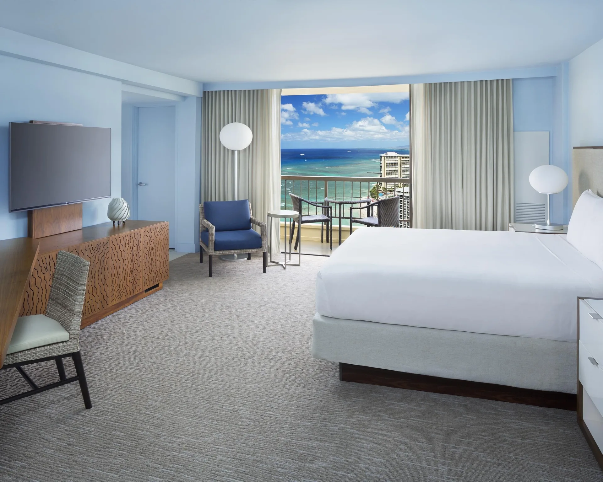 King bed Ocean View room at Hyatt Regency Waikiki Beach Resort & Spa with balcony beyond curtains.
