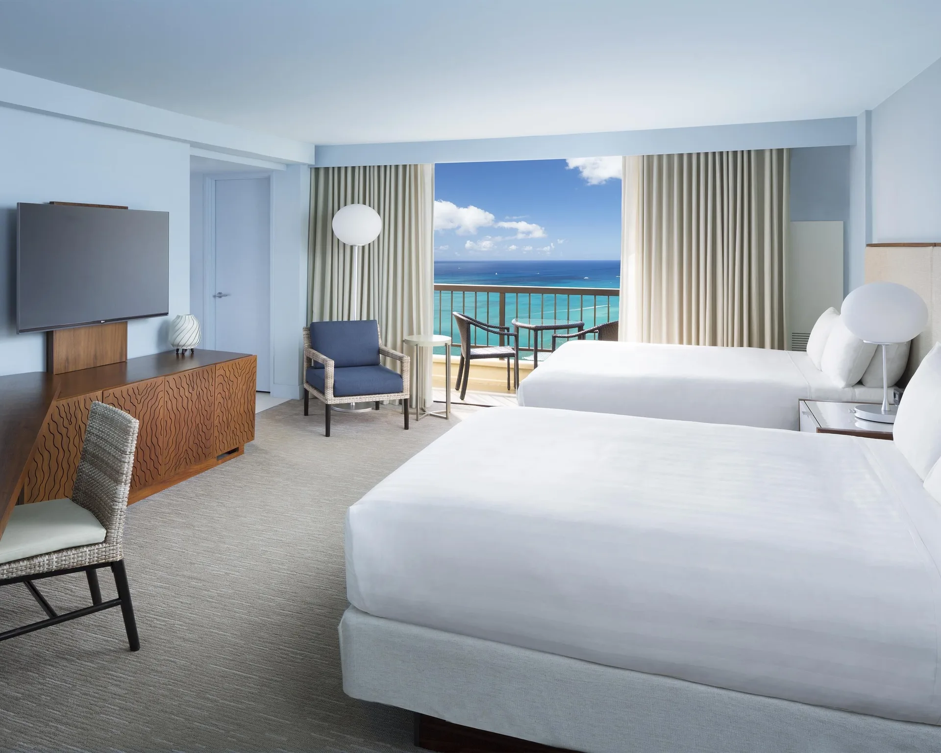Oceanfront room with two beds and bright balcony view at Hyatt Regency Waikiki Beach Resort & Spa.