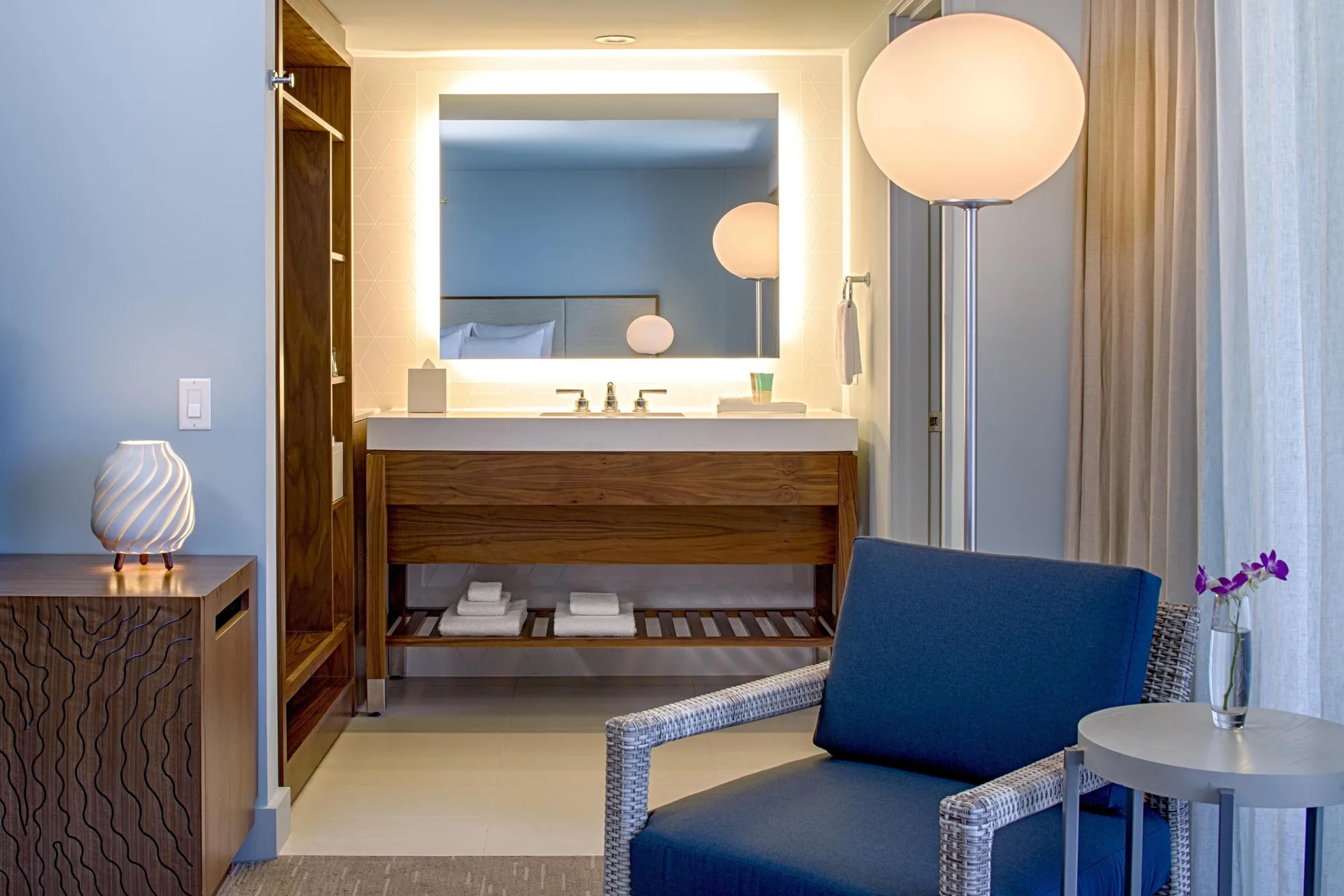 Waikiki View room vanity and sitting area at Hyatt Regency Waikiki Beach Resort & Spa.