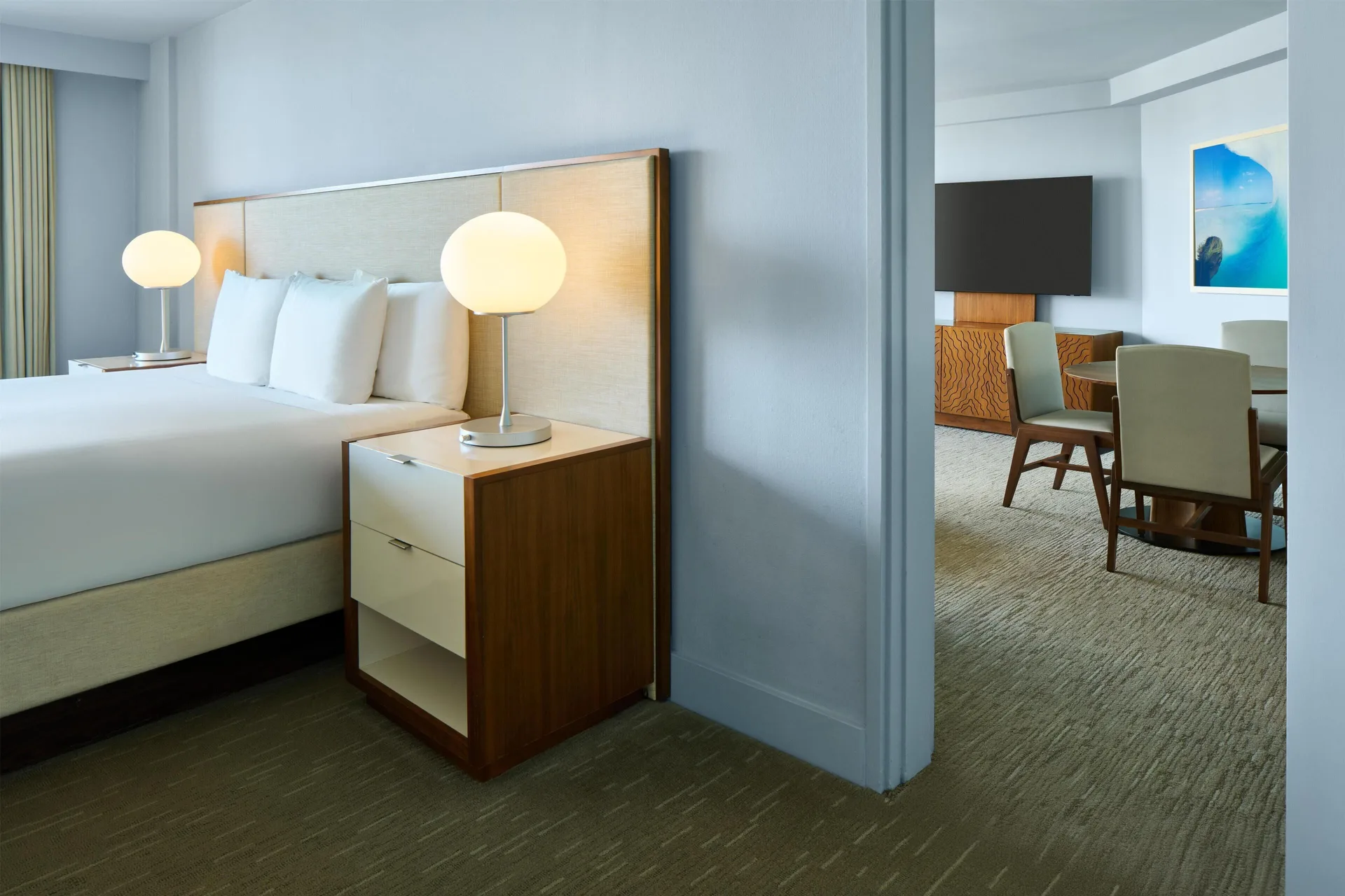 King bedroom beside a separate sitting area at Hyatt Regency Waikiki Beach Resort & Spa.