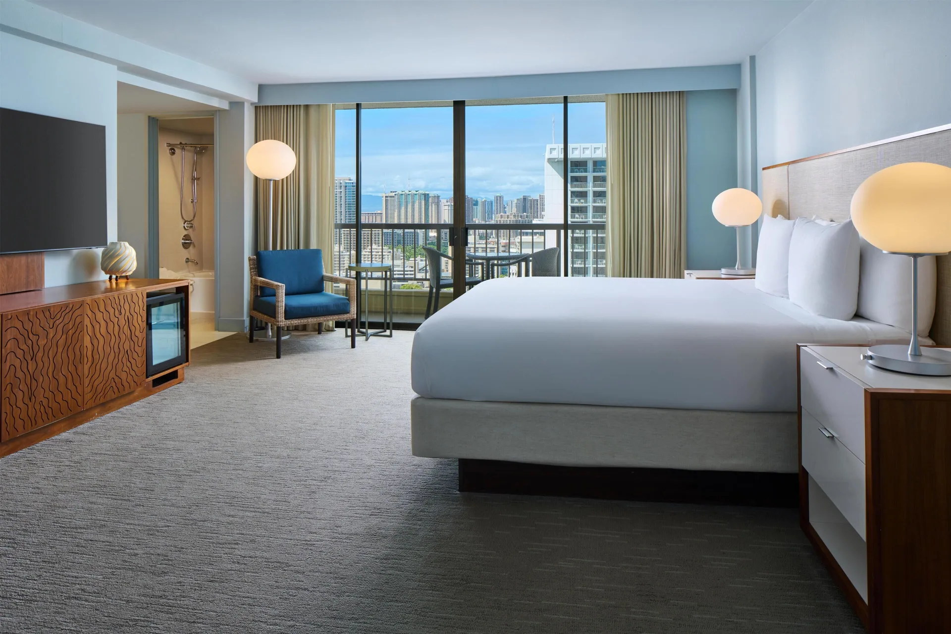 Waikiki view one-bedroom suite with king bed at Hyatt Regency Waikiki Beach Resort & Spa.