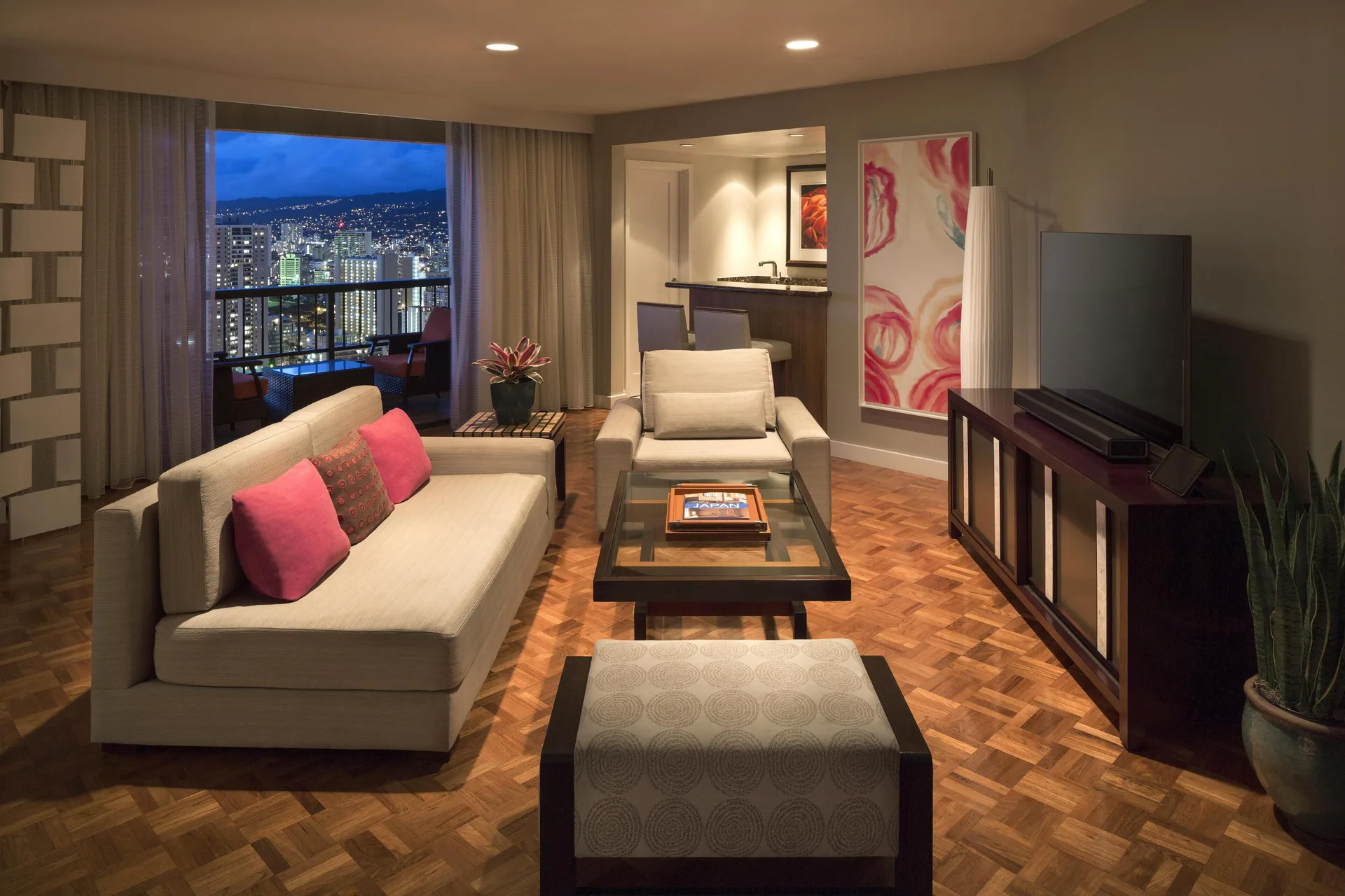 Two Bedroom Ambassador Suite living room at Hyatt Regency Waikiki Beach Resort & Spa with city-view balcony.