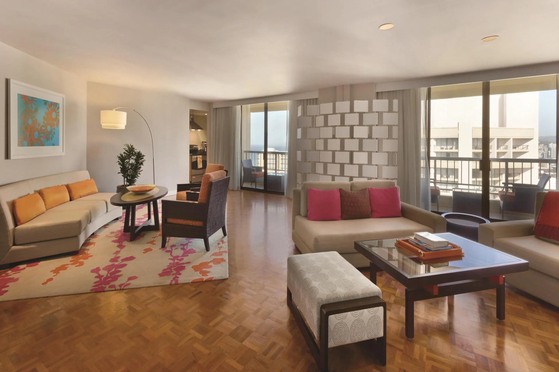 Two Bedroom Ambassador Suite lounge at Hyatt Regency Waikiki Beach Resort & Spa with seating and balconies.