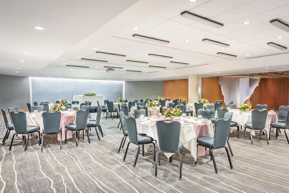 Round banquet tables set with flowers in an event room at Hyatt Regency Waikiki Beach Resort & Spa.