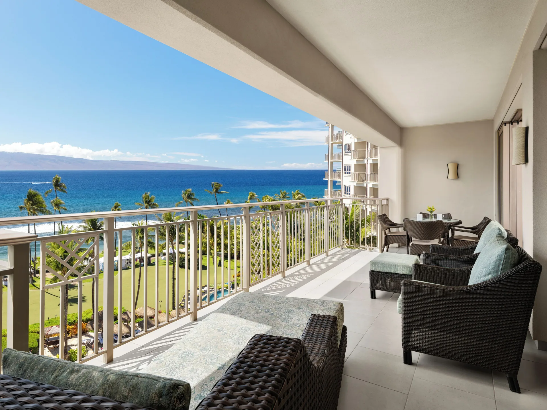 Ocean-view balcony seating at Hyatt Vacation Club at Ka'anapali Beach with palms and coastline beyond.