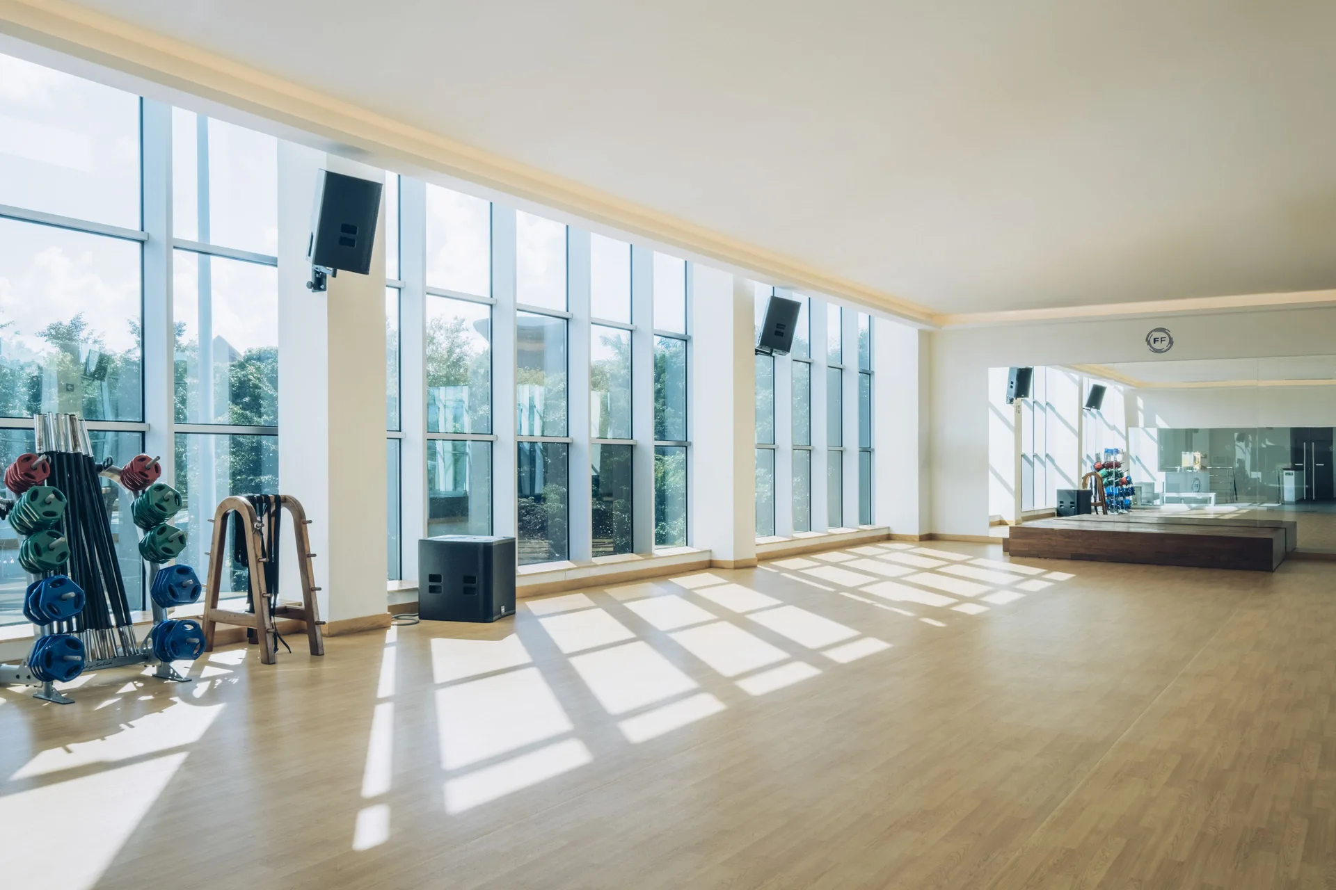 Bright fitness studio with mirrors and exercise equipment at Iberostar Waves Paraíso del Mar.
