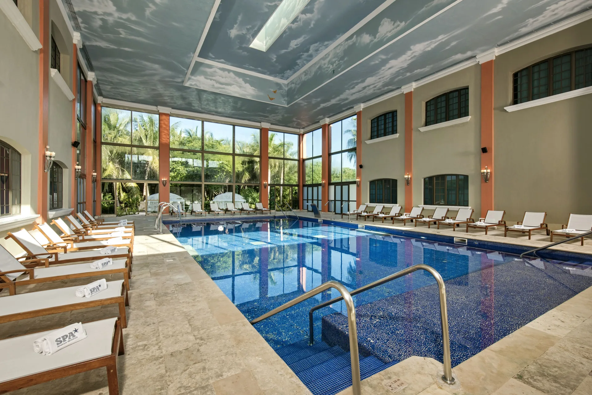Large indoor spa pool with loungers at Iberostar Waves Paraíso del Mar.