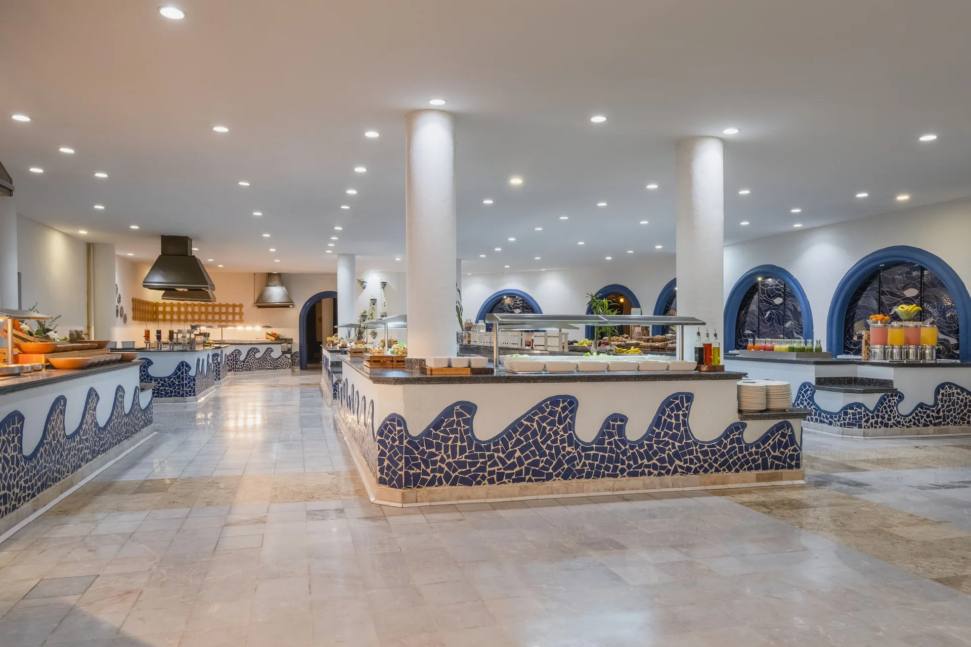 White and blue buffet room with mosaic wave counters at Iberostar Waves Paraíso del Mar.
