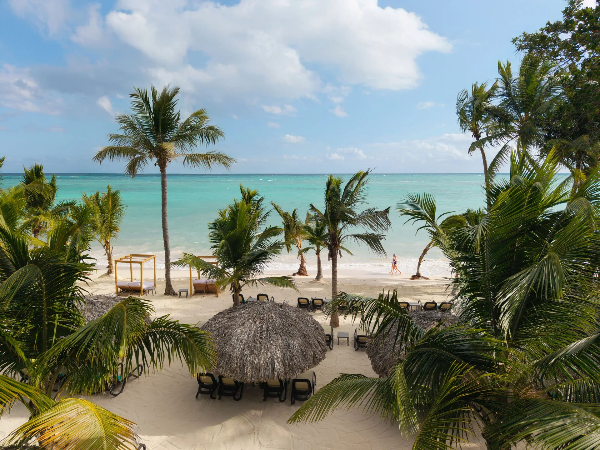Palm-framed beach and turquoise water at Impressive Premium Punta Cana.
