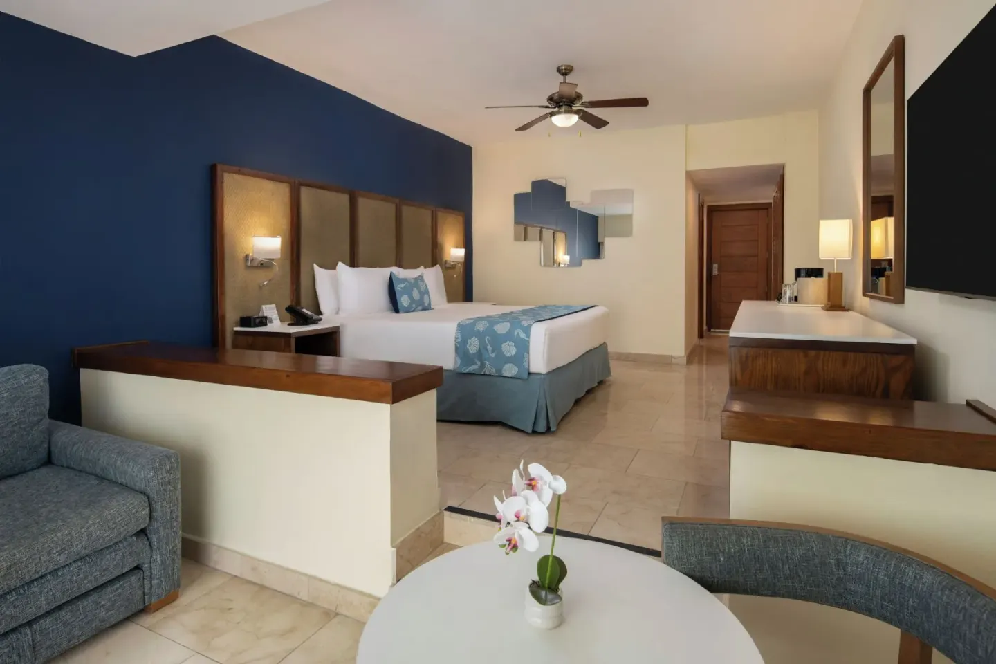 Junior Suite Premium Ocean View bedroom with king bed and sitting area at Impressive Premium Punta Cana.