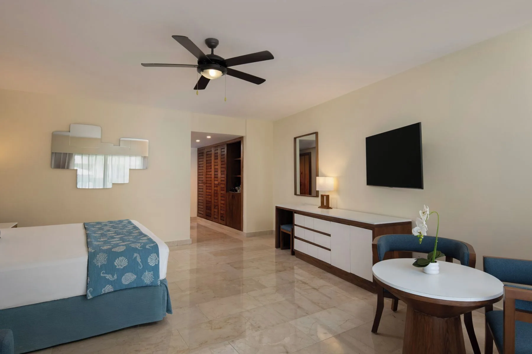 Junior Suite Premium Pool View room with king bed and seating at Impressive Premium Punta Cana.