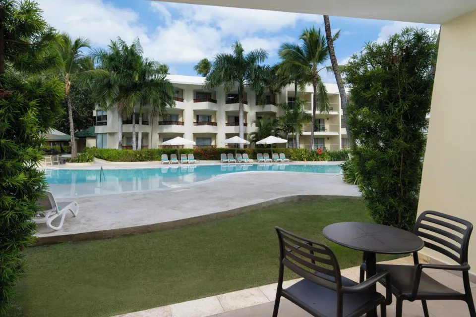 Junior Suite Premium Pool View patio facing the pool at Impressive Premium Punta Cana.