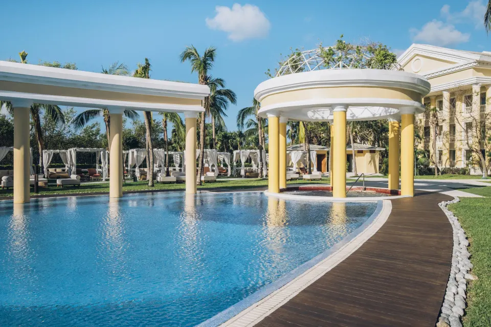 Curved pool edge with pavilion and cabanas at JOIA Paraíso by Iberostar.