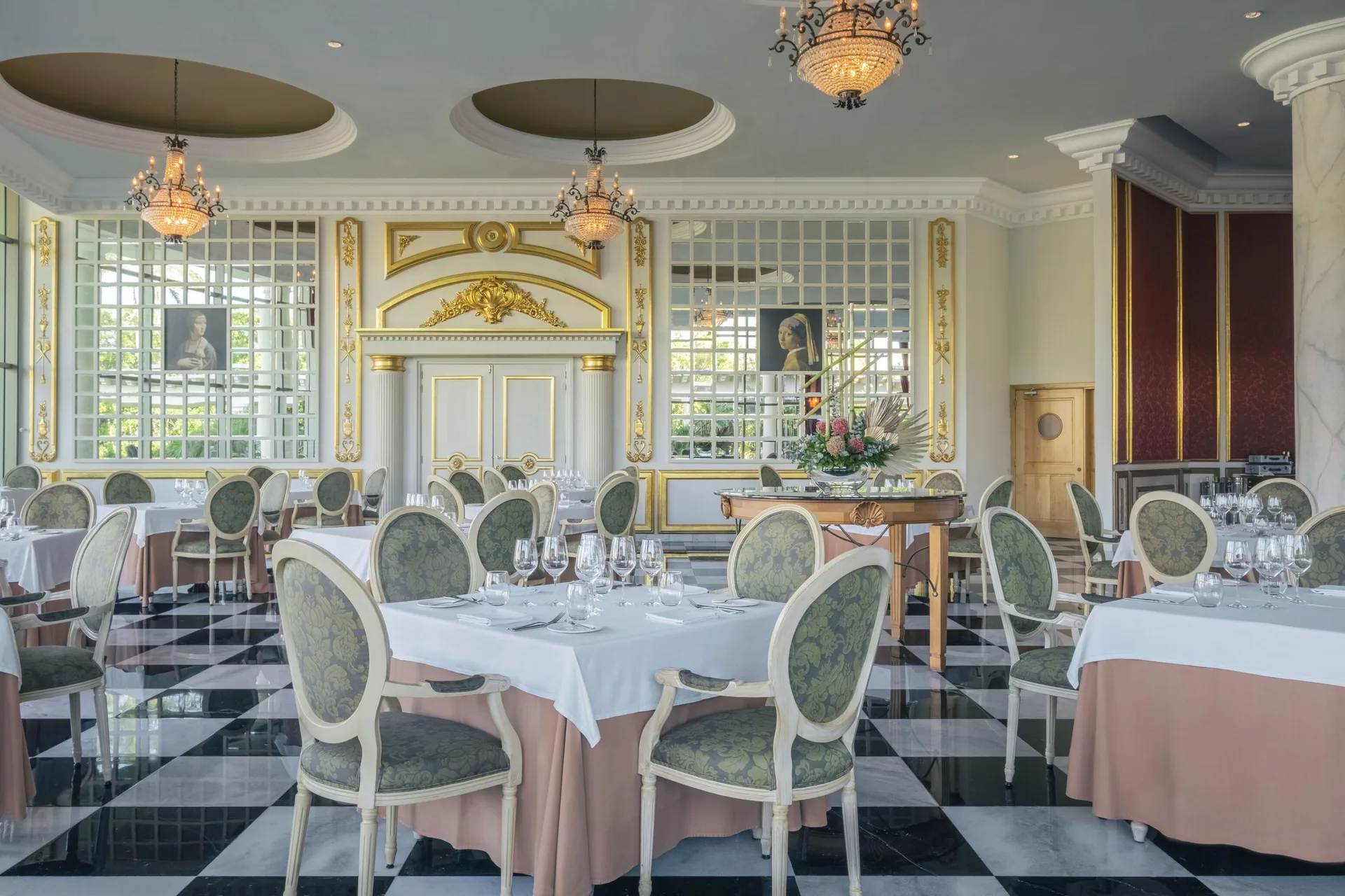 Elegant dining room with chandeliers and white table settings at JOIA Paraíso by Iberostar.