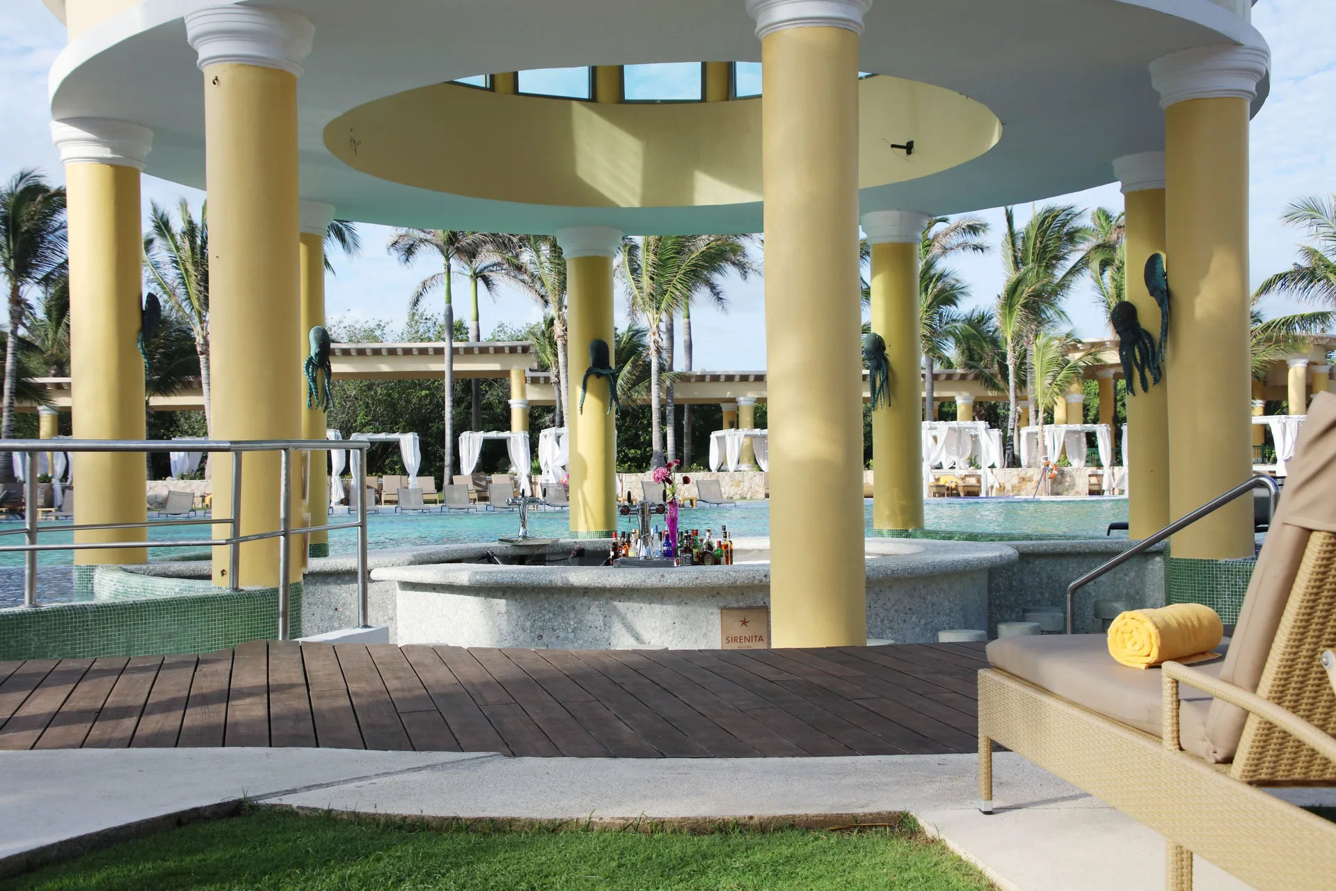 Pool bar under a yellow pavilion at JOIA Paraíso by Iberostar.
