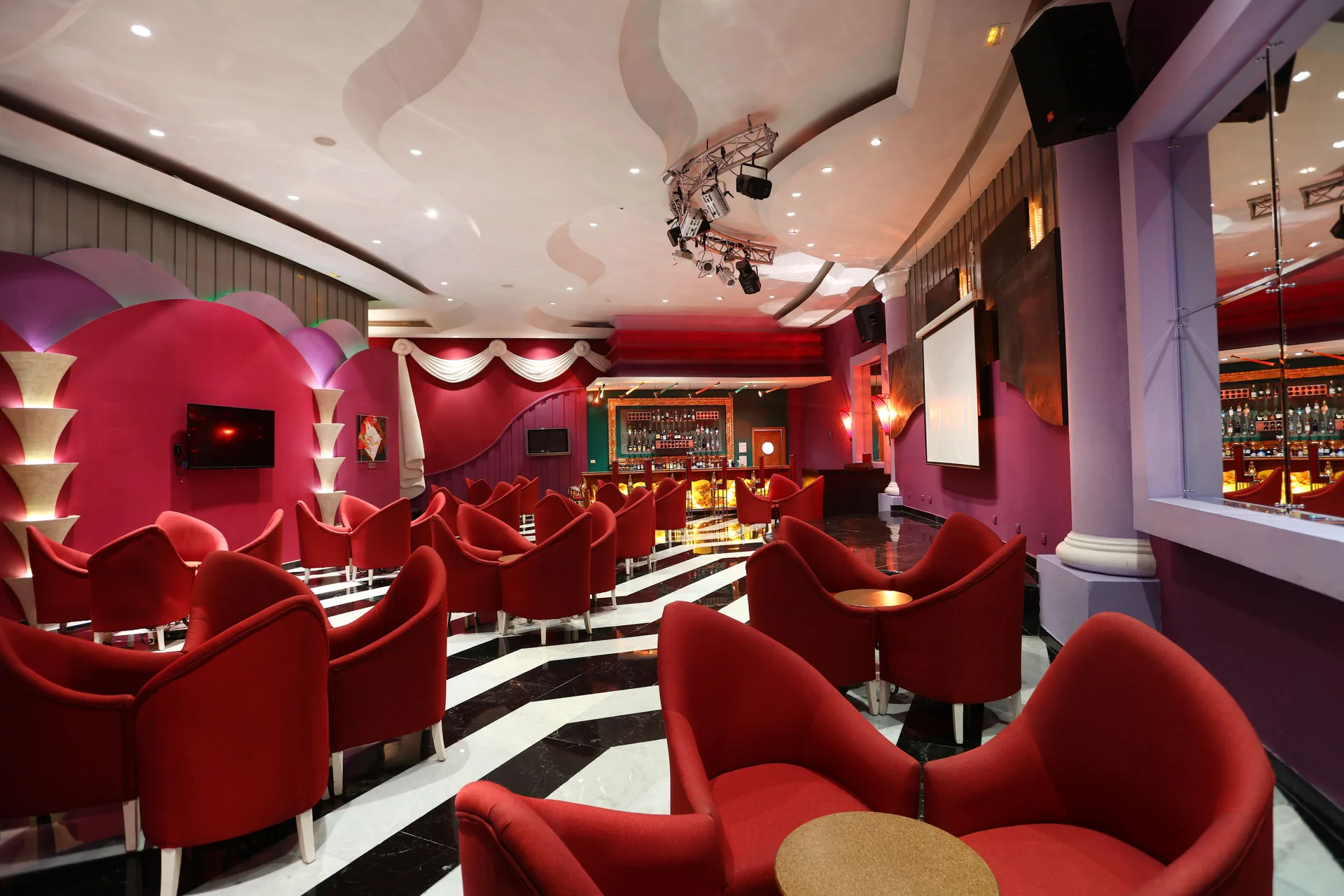 A red and purple music bar lounge at JOIA Paraíso by Iberostar.