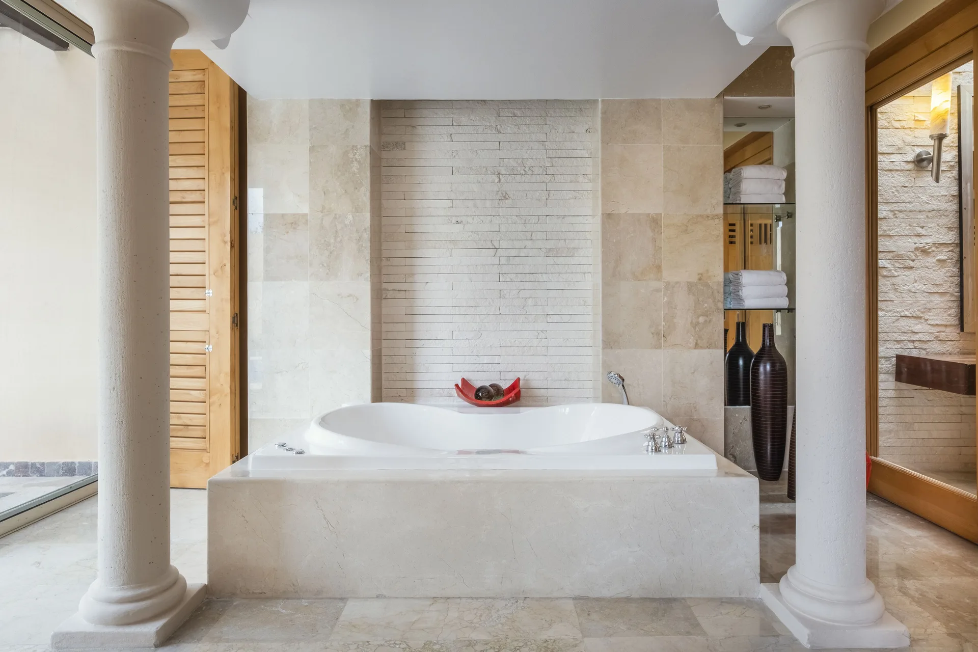 Romantic Villa bathroom with soaking tub and columns at JOIA Paraíso by Iberostar.