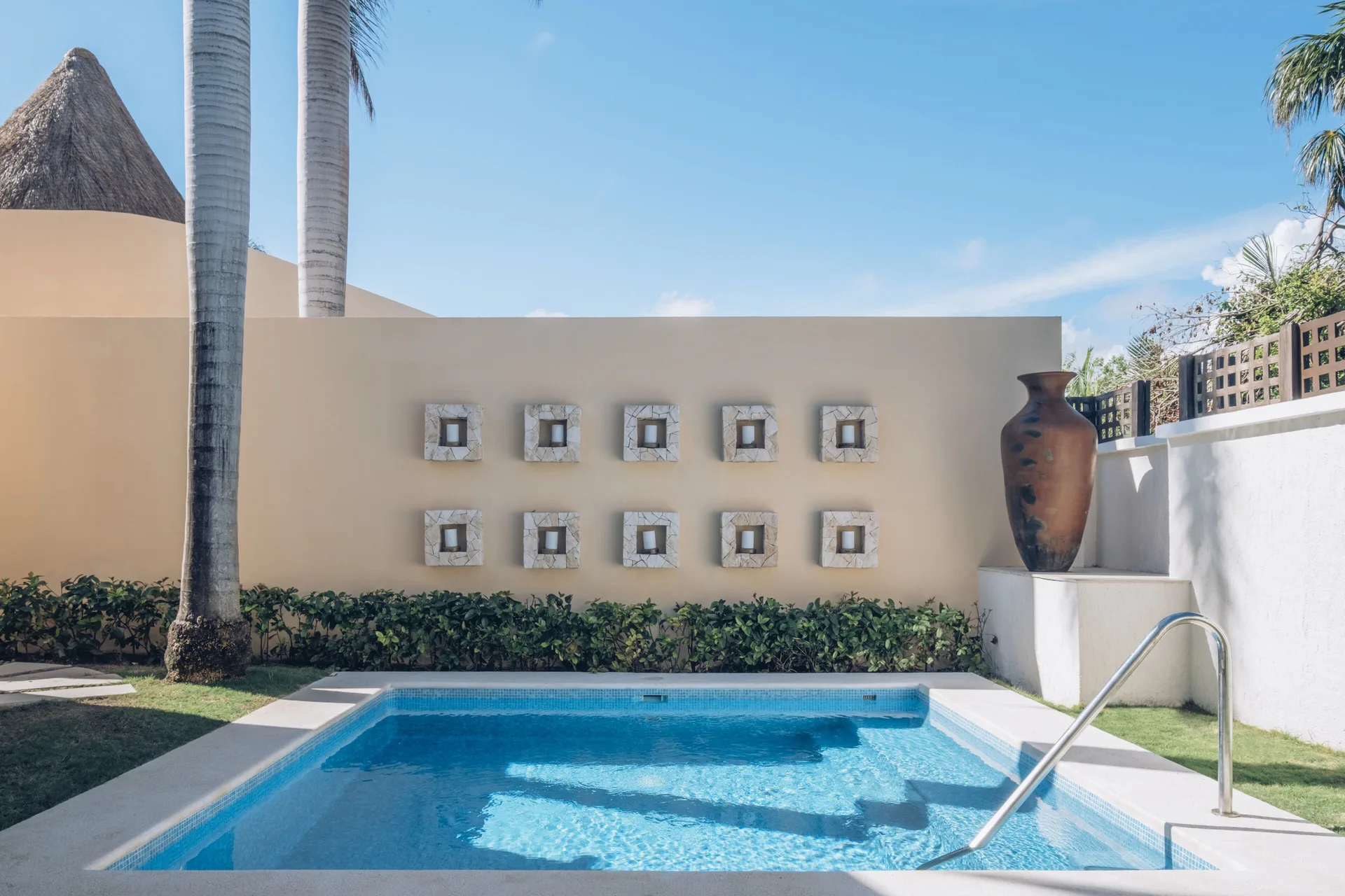 Romantic Villa pool with decorative wall and vase at JOIA Paraíso by Iberostar.