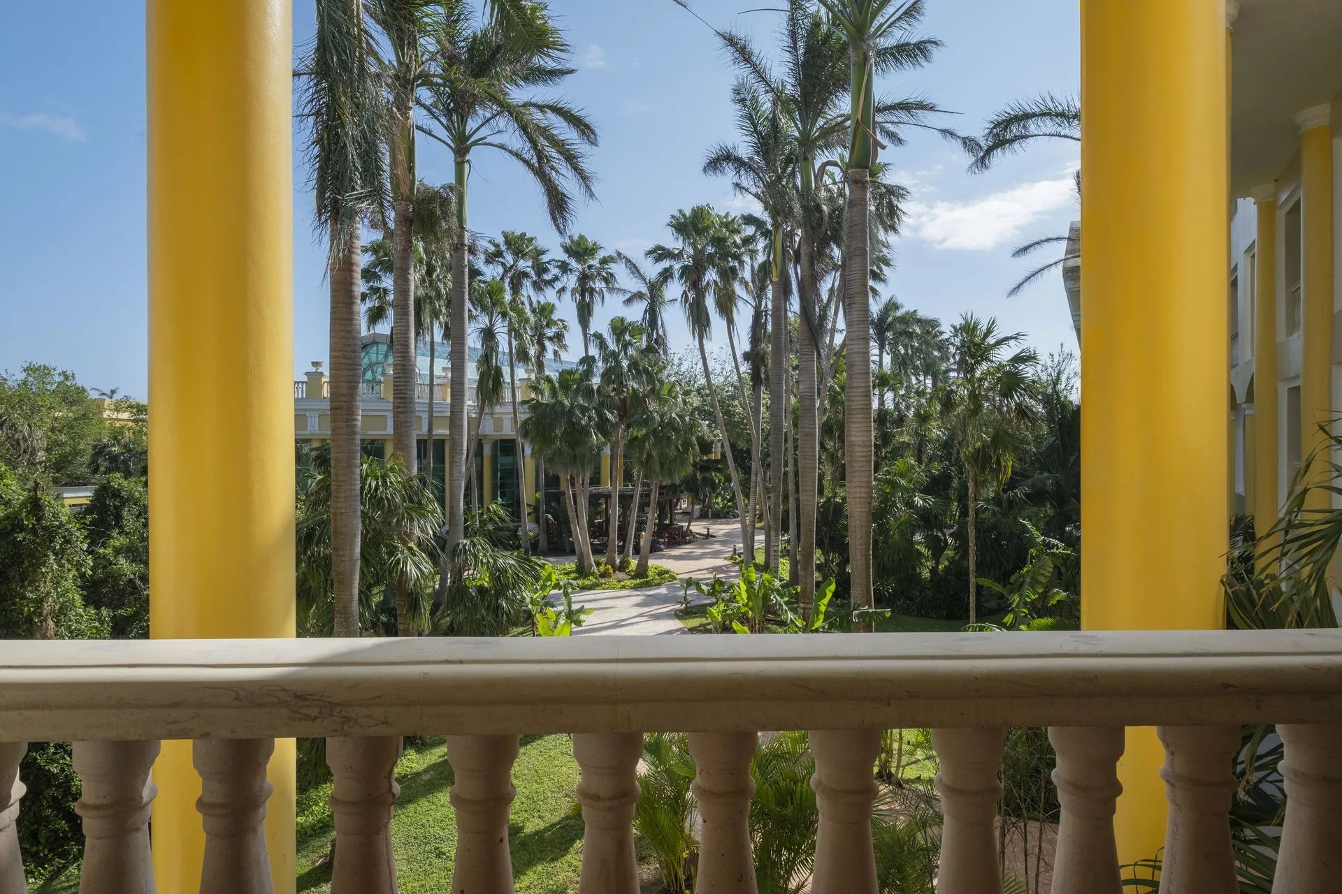 Suite balcony view of palms and gardens at JOIA Paraíso by Iberostar.