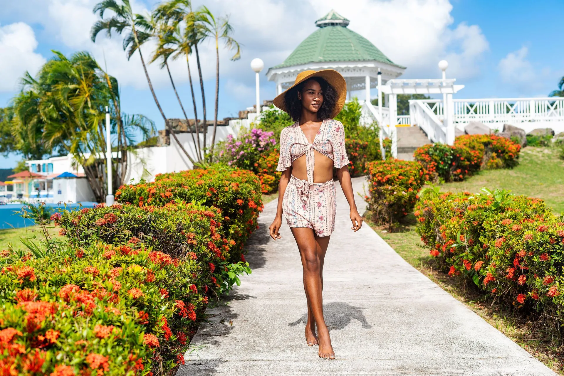 Guest walking through the garden path at Jolly Beach Antigua with a gazebo behind.