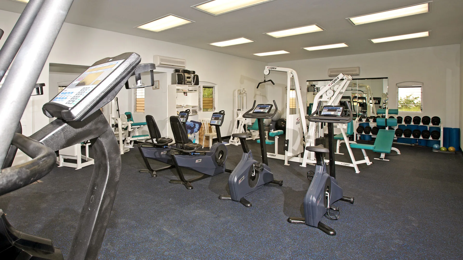 Gym with cardio machines, weights, and benches at Jolly Beach Antigua.