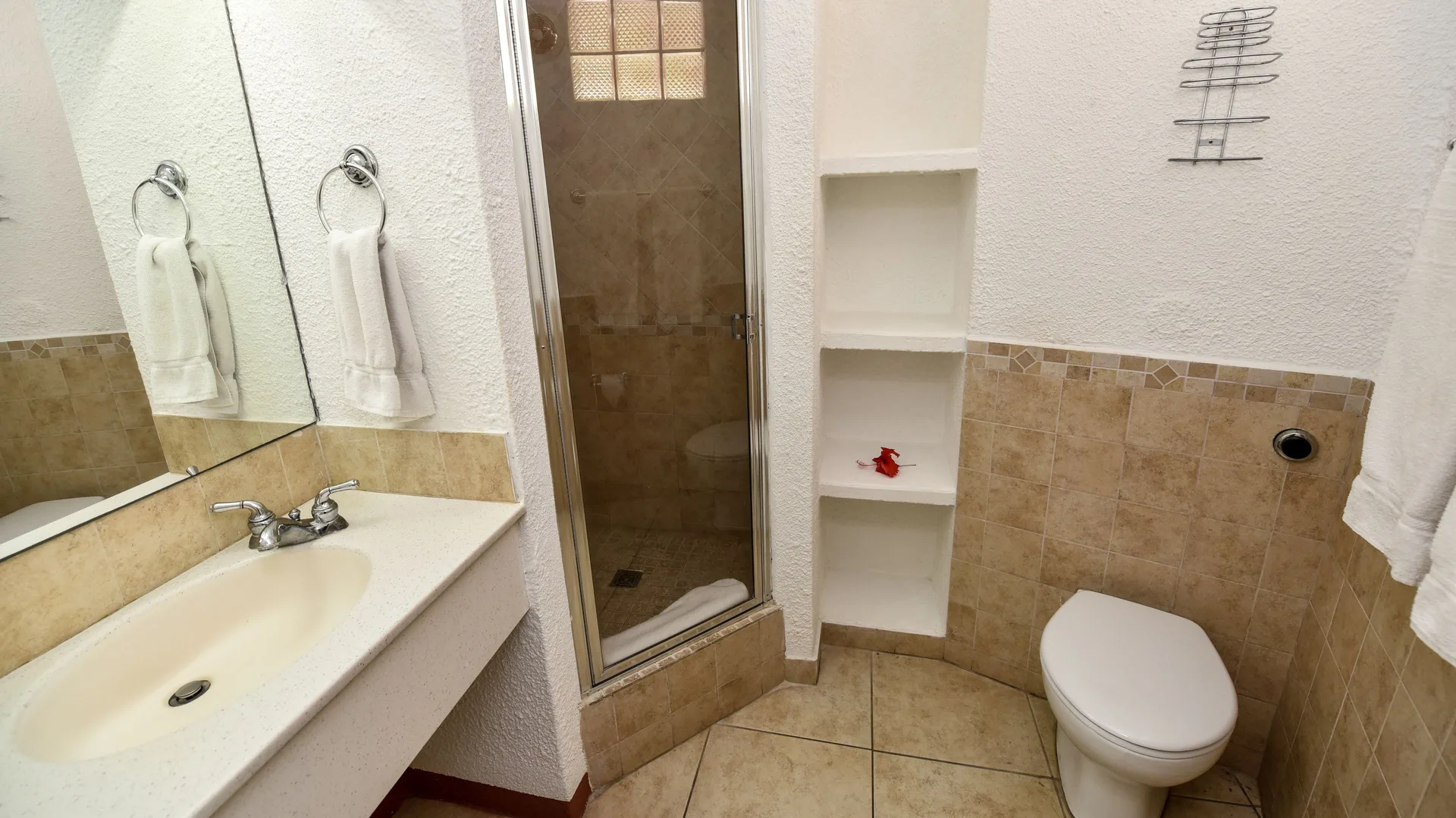 Super Saver Room bathroom with shower, sink, and toilet at Jolly Beach Antigua.