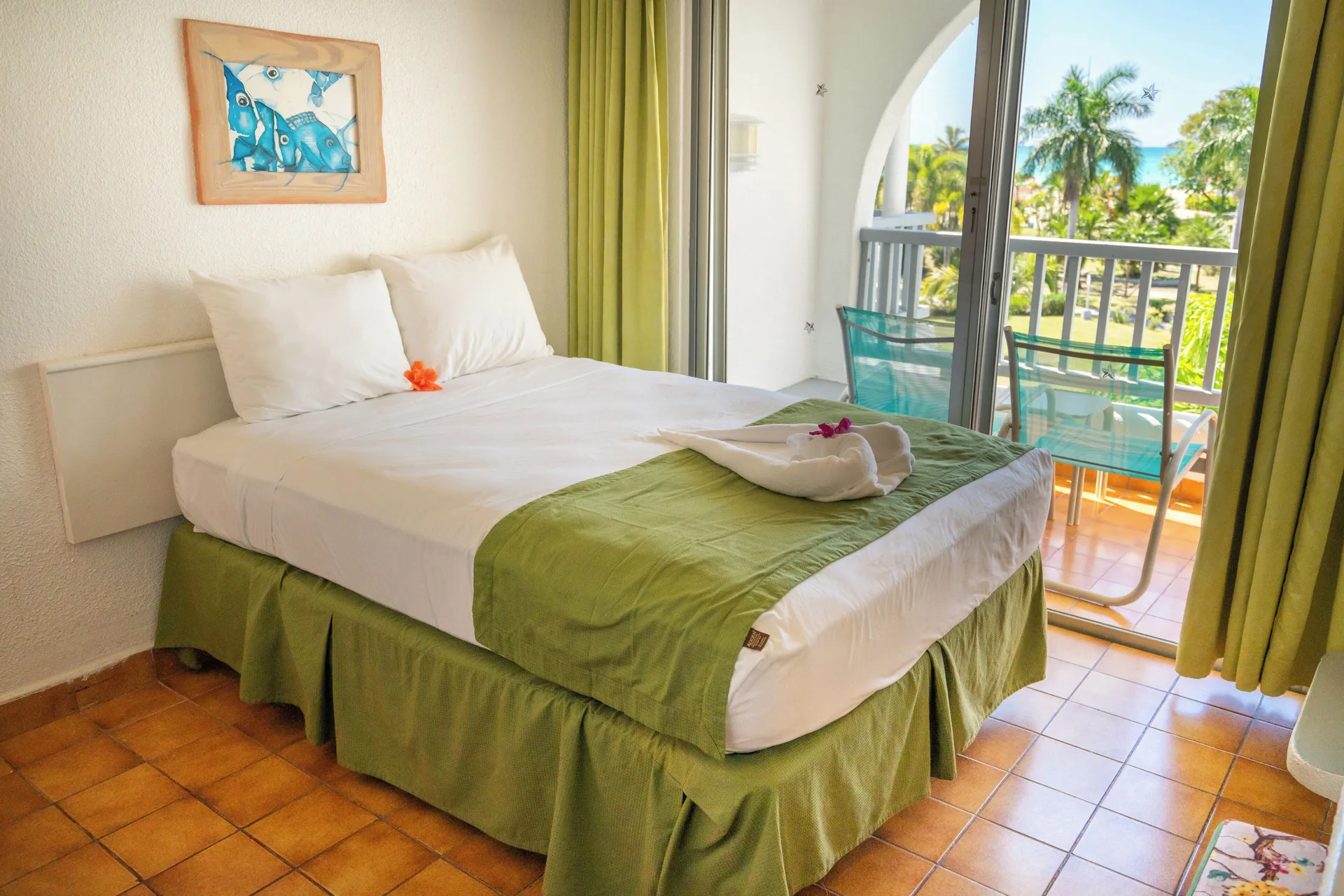 Super Saver Room double bed near balcony doors at Jolly Beach Antigua.
