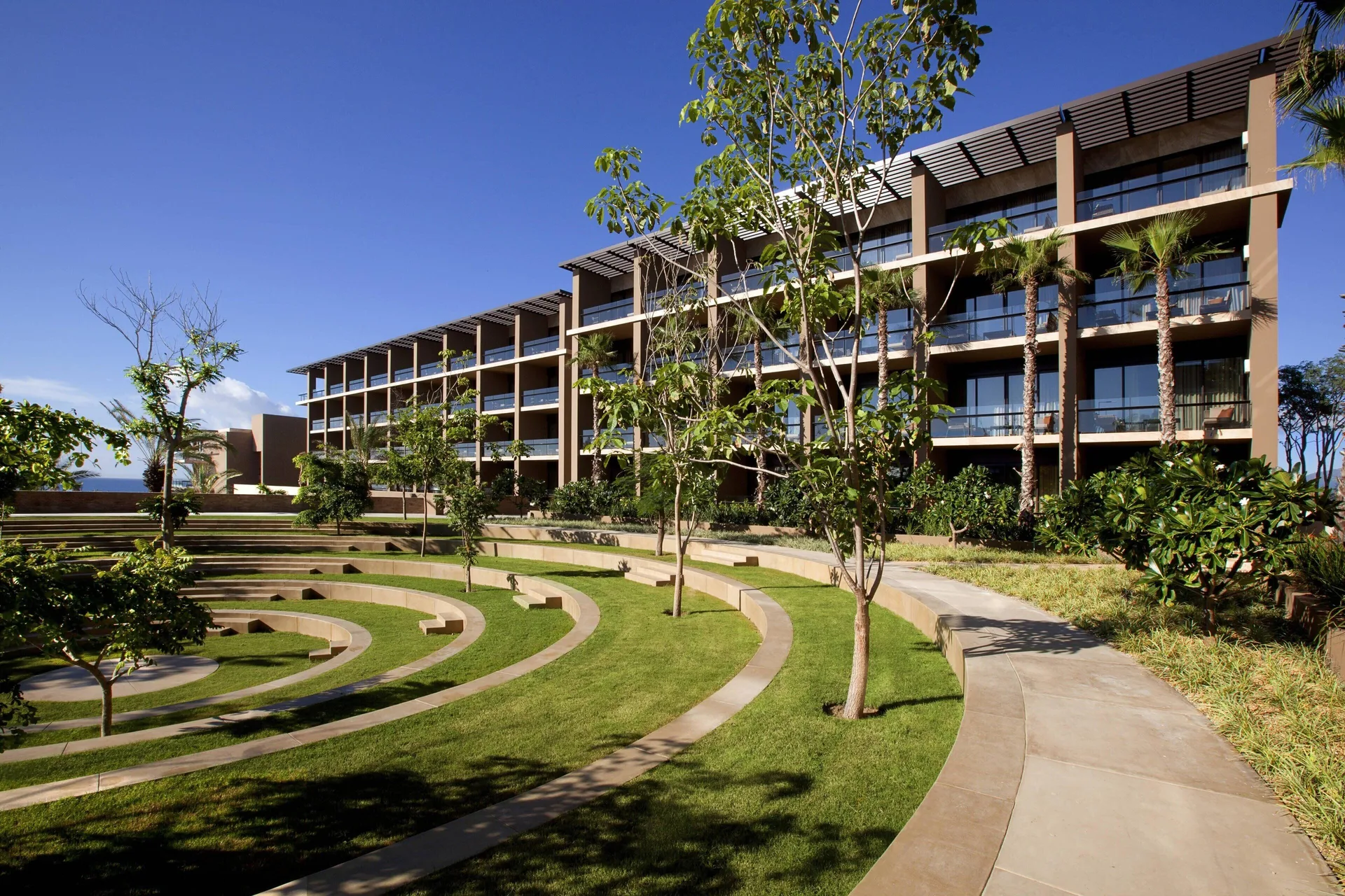 Garden pathways and guestroom balconies at JW Marriott Los Cabos Beach Resort & Spa.