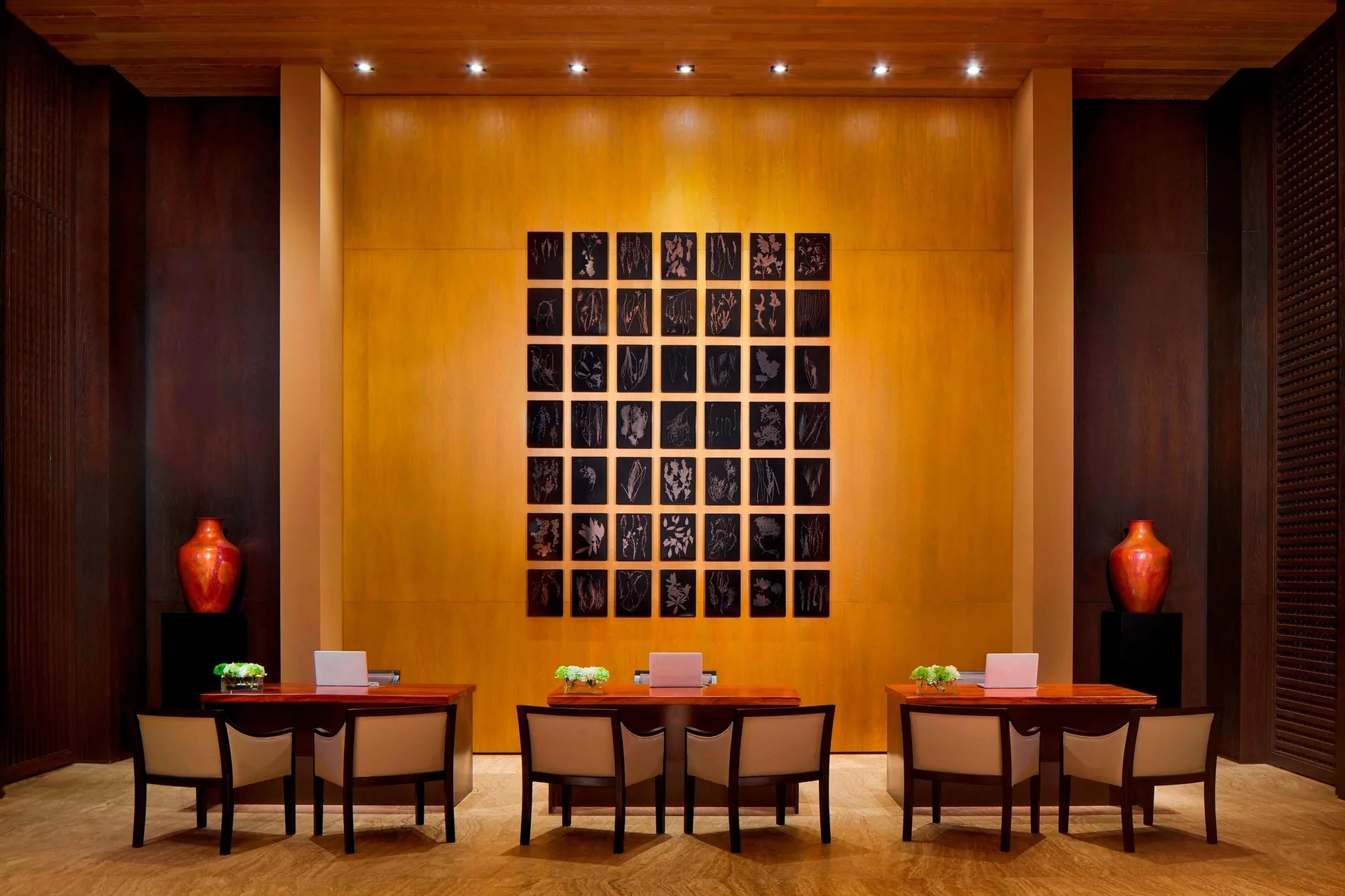 Reception seating area with desks and wall art at JW Marriott Los Cabos Beach Resort & Spa.