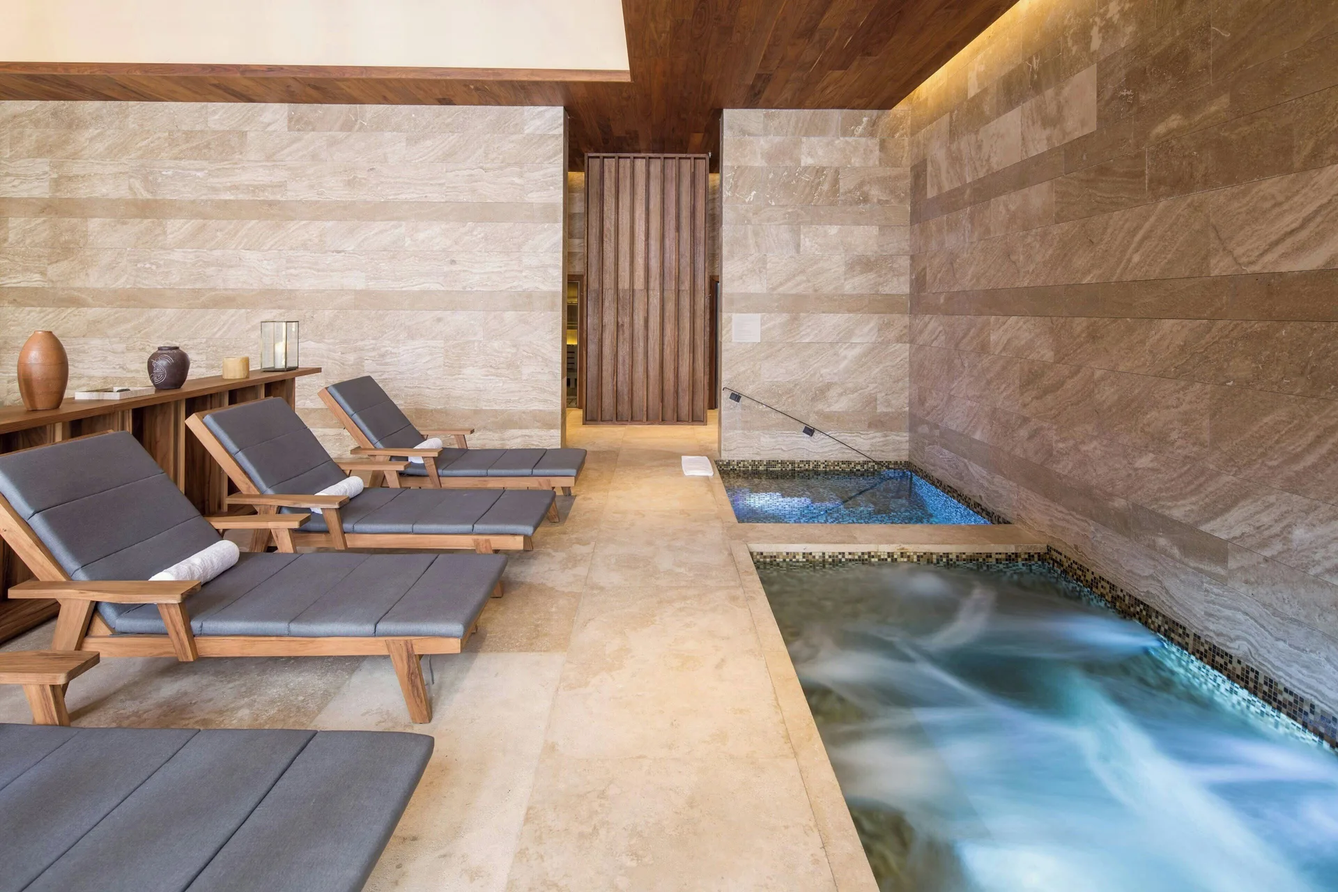 Spa loungers beside tiled soaking pools at JW Marriott Los Cabos Beach Resort & Spa.