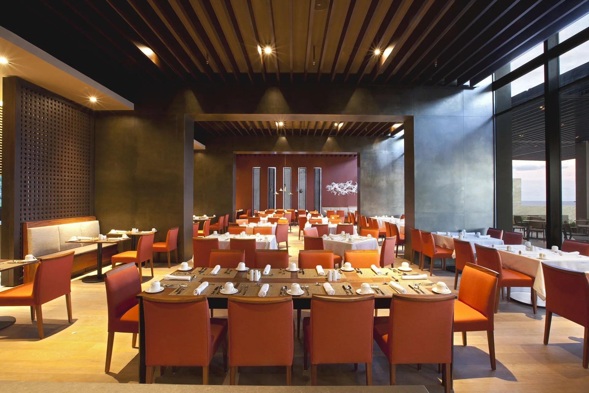 Modern restaurant dining room with orange chairs at JW Marriott Los Cabos Beach Resort & Spa.