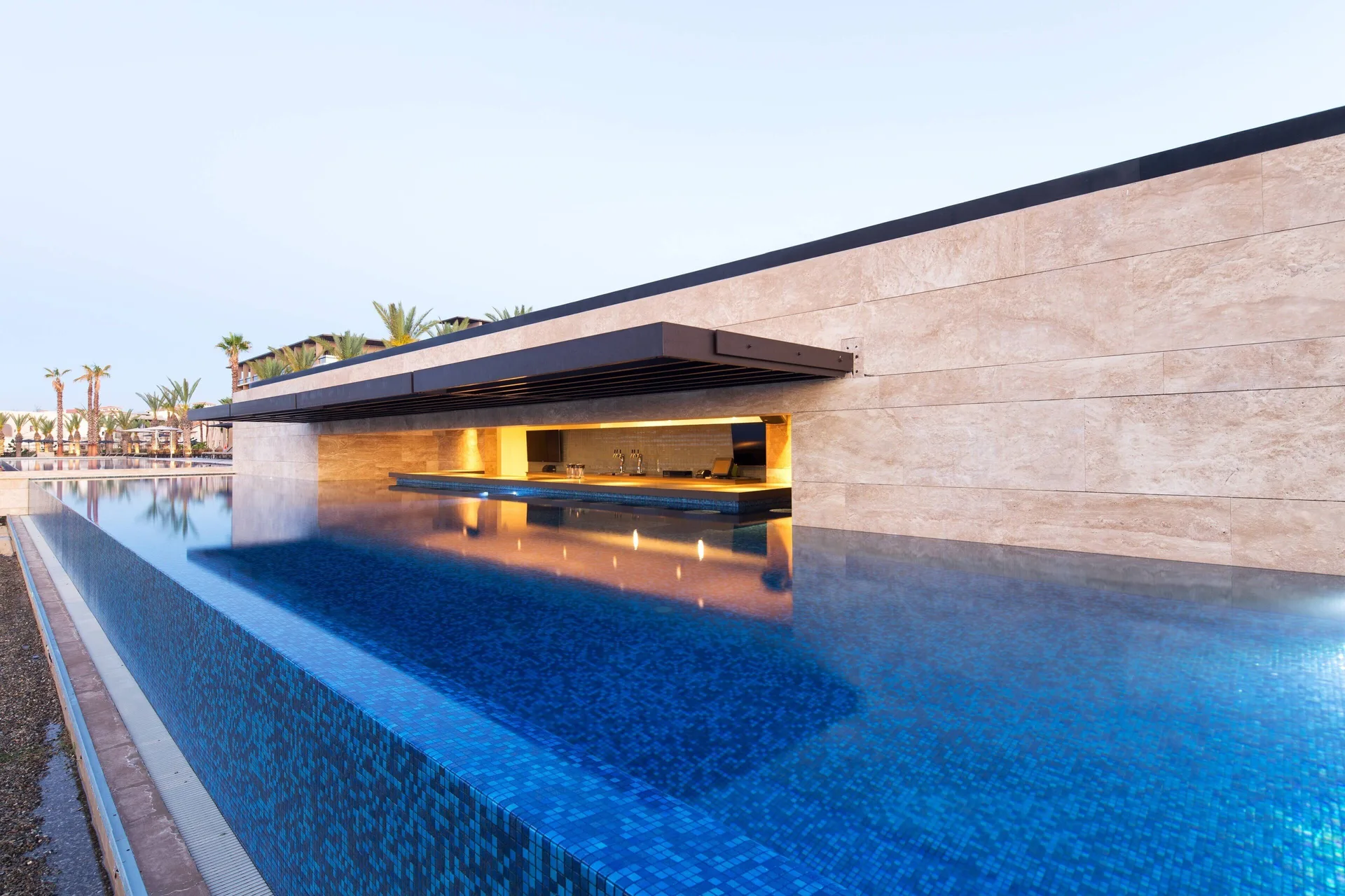 Swim-up style pool bar set into a stone wall at JW Marriott Los Cabos Beach Resort & Spa.