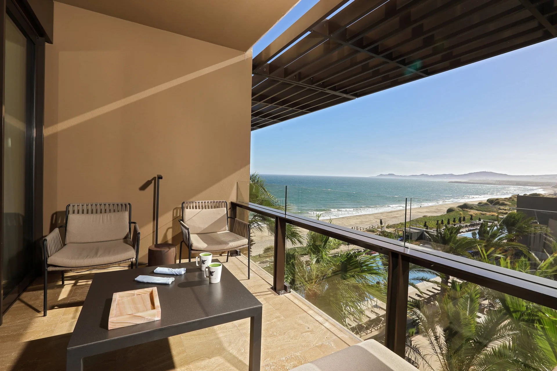 Ocean-view balcony seating for a Deluxe Room at JW Marriott Los Cabos Beach Resort & Spa.