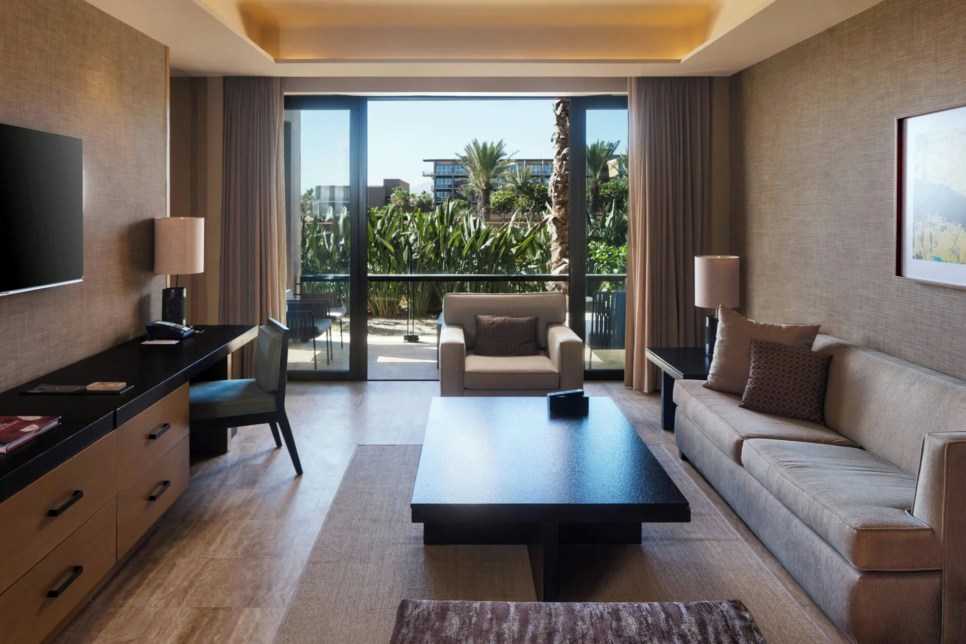 Luxury Suite living area with sofa bed and balcony view at JW Marriott Los Cabos Beach Resort & Spa.