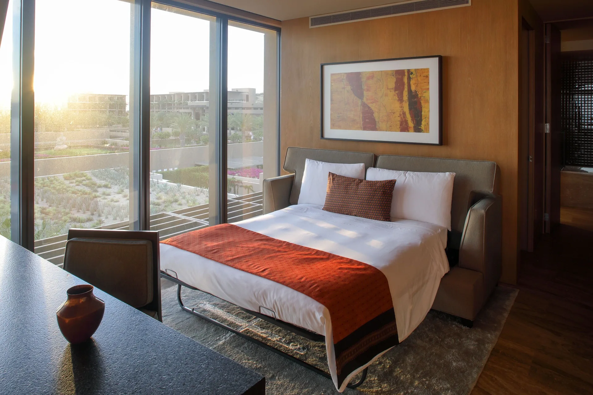Panoramic Room with king bed and floor-to-ceiling windows at JW Marriott Los Cabos Beach Resort & Spa.