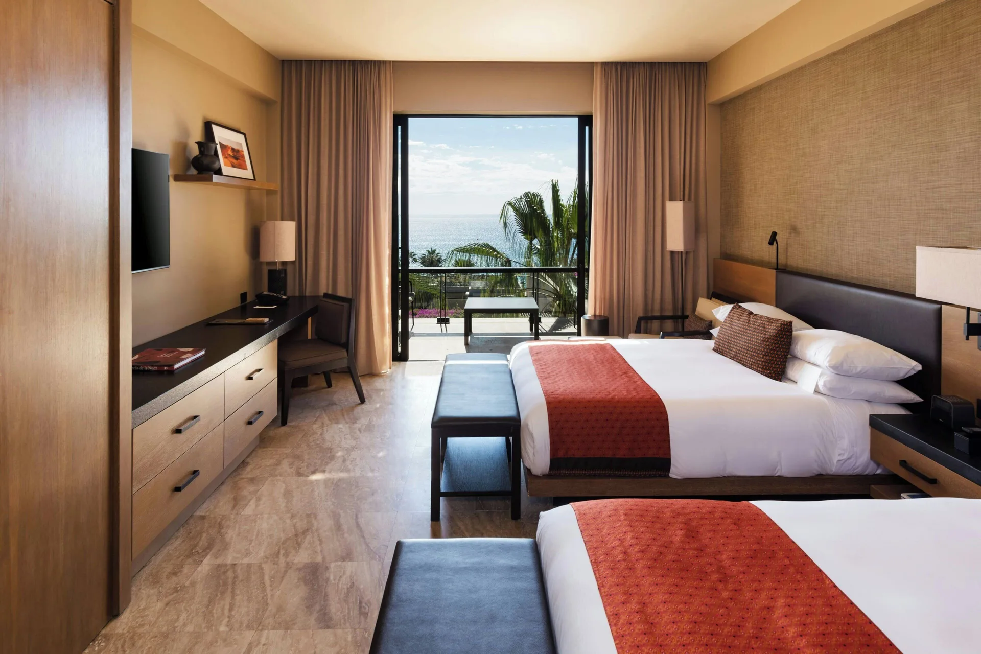 Panoramic Room with two beds, desk, TV, and ocean-view balcony at JW Marriott Los Cabos Beach Resort & Spa.