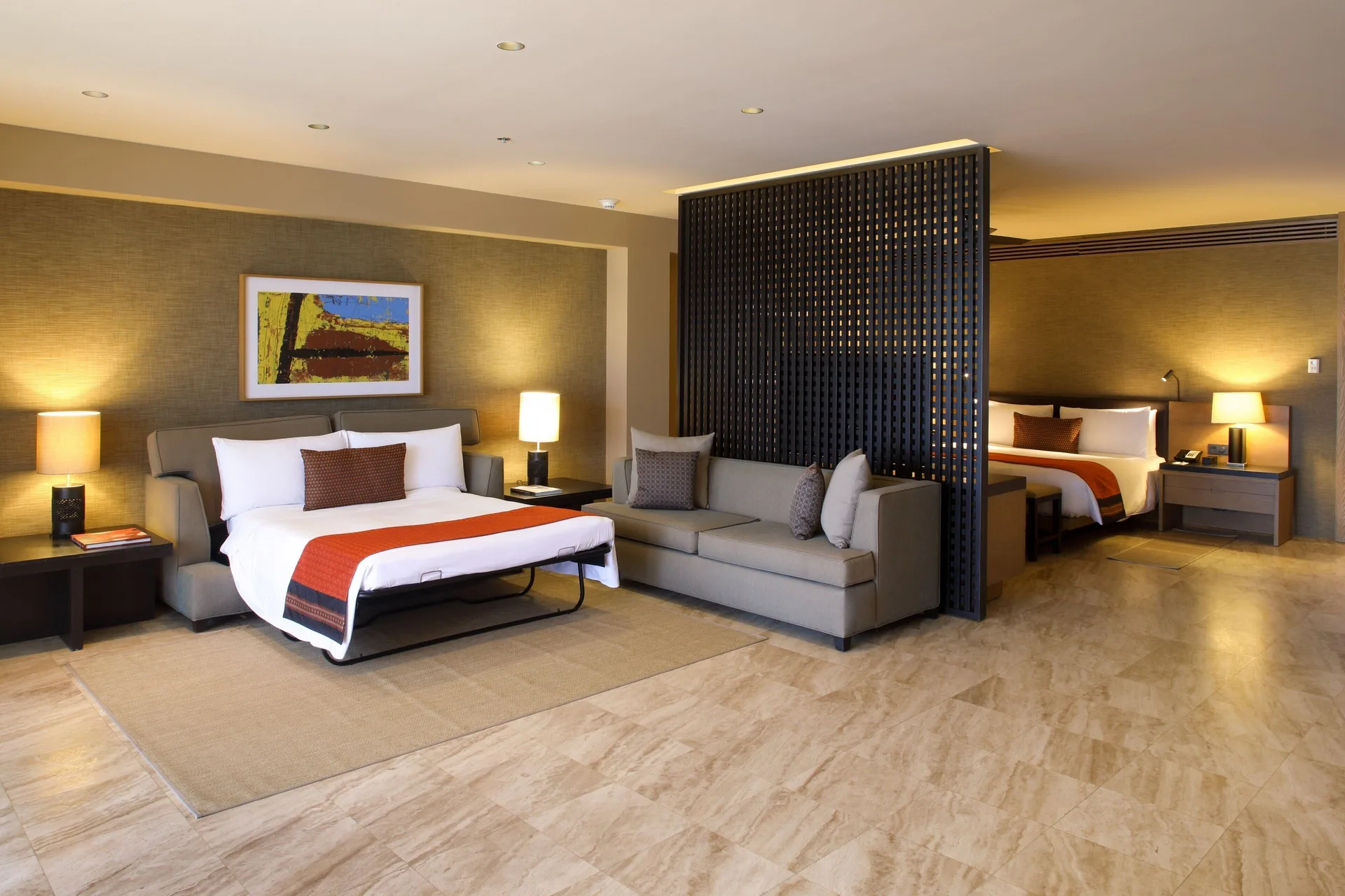 Panoramic Room suite layout with two beds and seating at JW Marriott Los Cabos Beach Resort & Spa.
