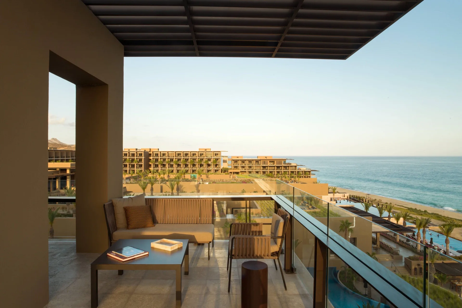 Oceanfront suite balcony with seating and sea view at JW Marriott Los Cabos Beach Resort & Spa.