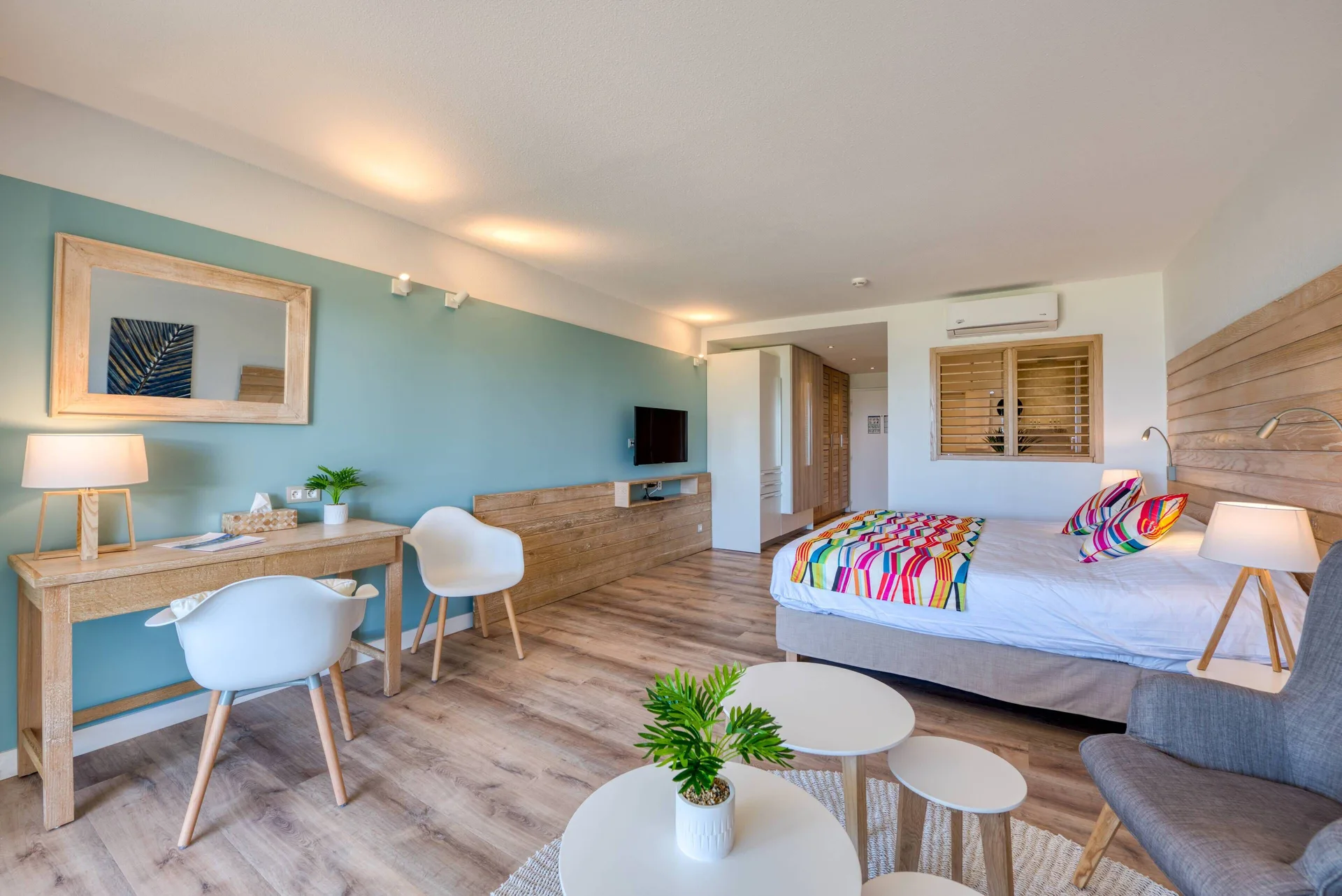 Junior Suite Kitchen Premium Garden king bed, desk, and seating at La Playa Orient Bay.