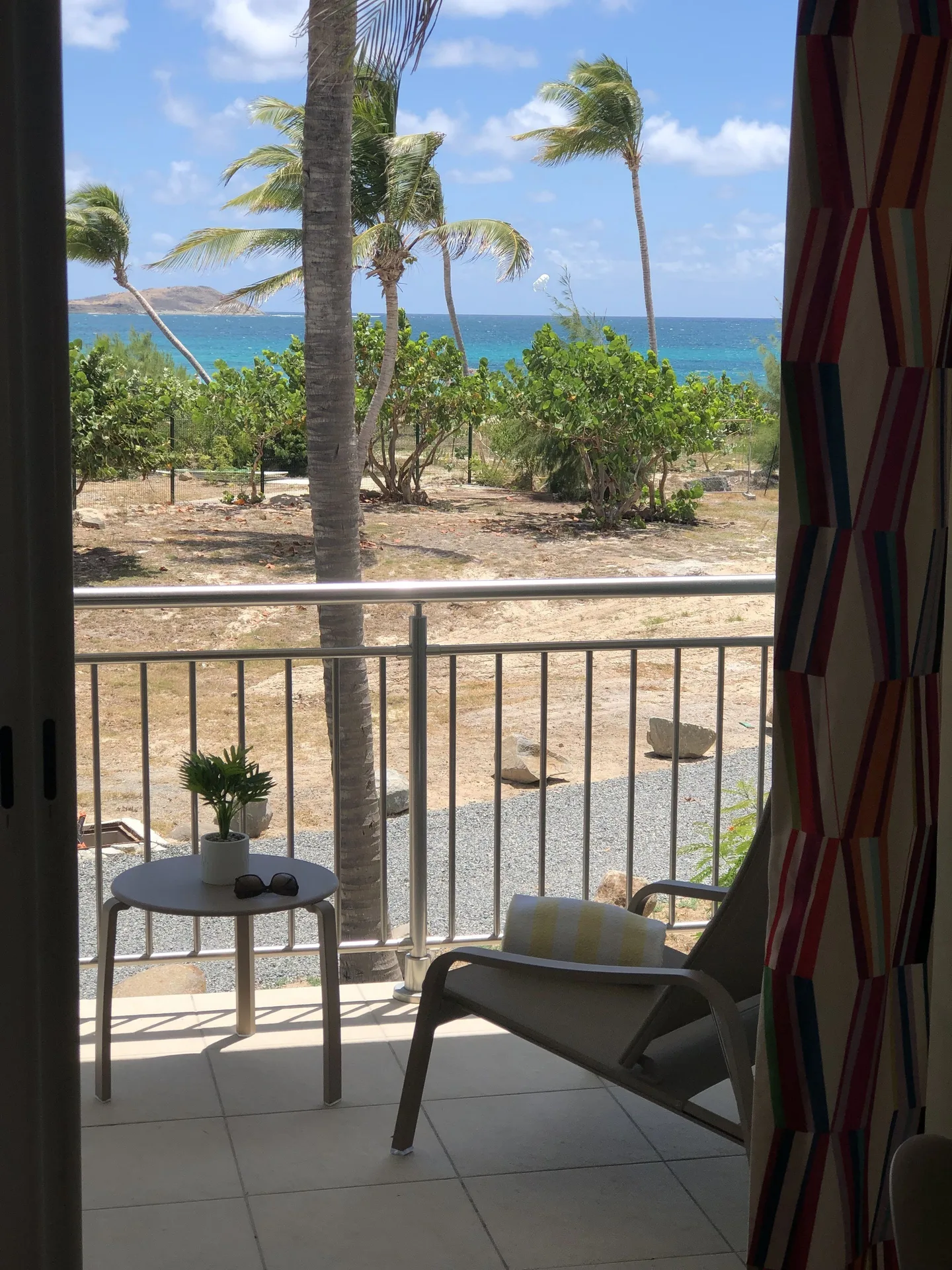 Junior Suite Kitchen Premium Ocean balcony with chair and sea view at La Playa Orient Bay.