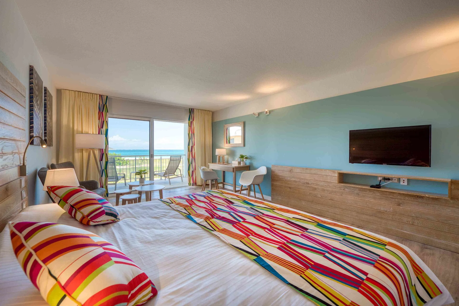 Junior Suite Kitchen Premium Ocean with king bed and balcony view at La Playa Orient Bay.