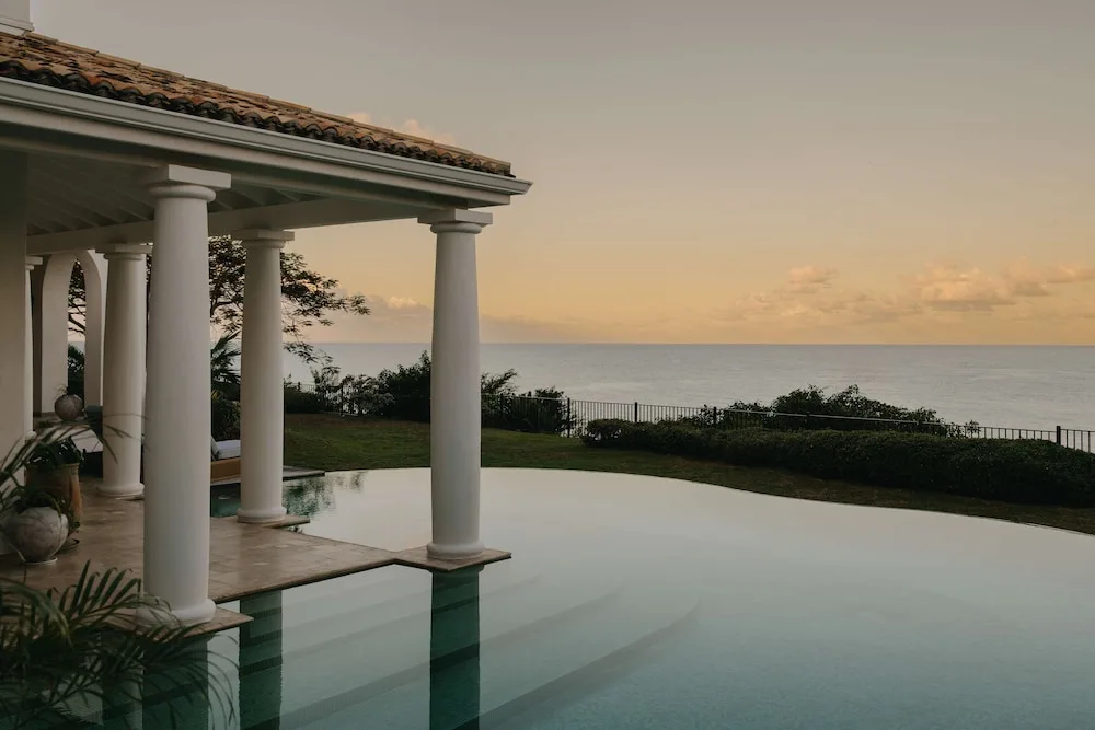 Infinity pool beside a columned terrace overlooking the sea at La Samanna, St Martin.